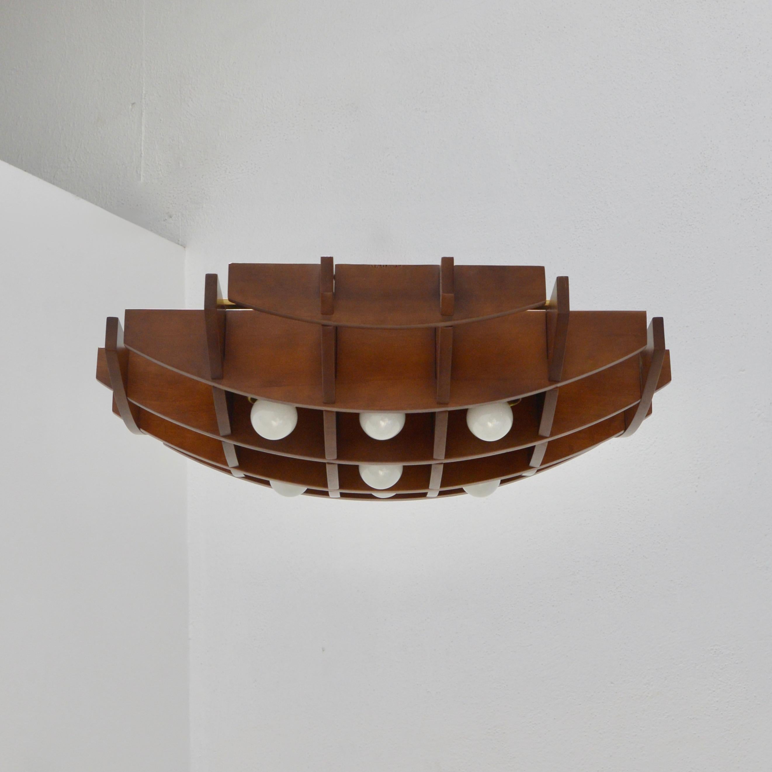 Esperia flush mount attributed to Manfredo Massironi from Italy. Cross hatching wood flush mount fixture with steel and brass hardware. Wired with 7 E12 candelabra based lights for the US.
Measurements:
Height 5.5”
Diameter 25.5” square.
 