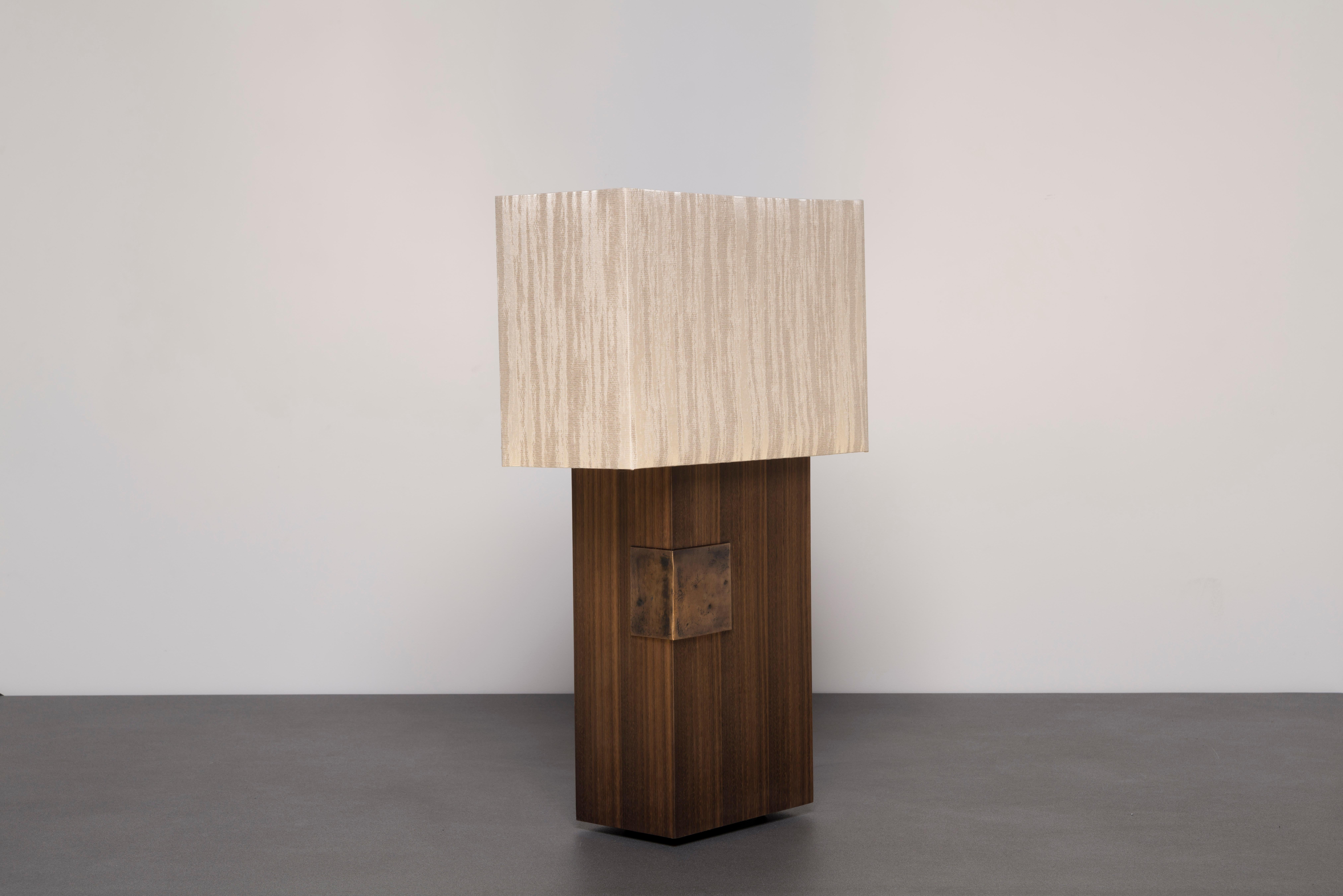 Esperia Table Lamp by Arch Plus Ultra
Dimensions: W 42 x D 21 x H 72 cm.
Materials: Eucalyptus thermowood, Cast bronze, Linen silk jacquard.

Esperia is a table lamp with base in Eucalyptus wood, that through a thermal process achieves a velvety
