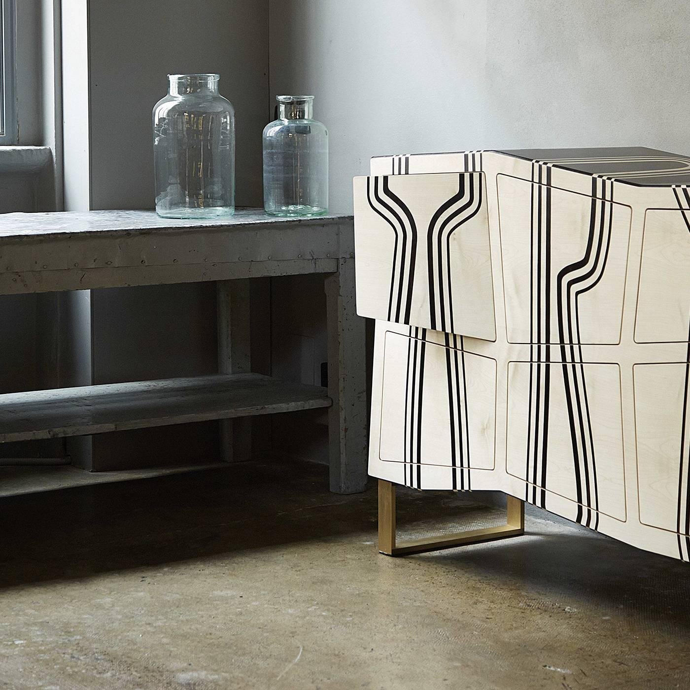 The unique and complex design of this eye-catching cabinet seems to challenge the classic tradition of cabinetmaking with its unexpected geometrical silhouette. Crafted entirely of maple wood, the frame is characterized by sharp and uneven lines