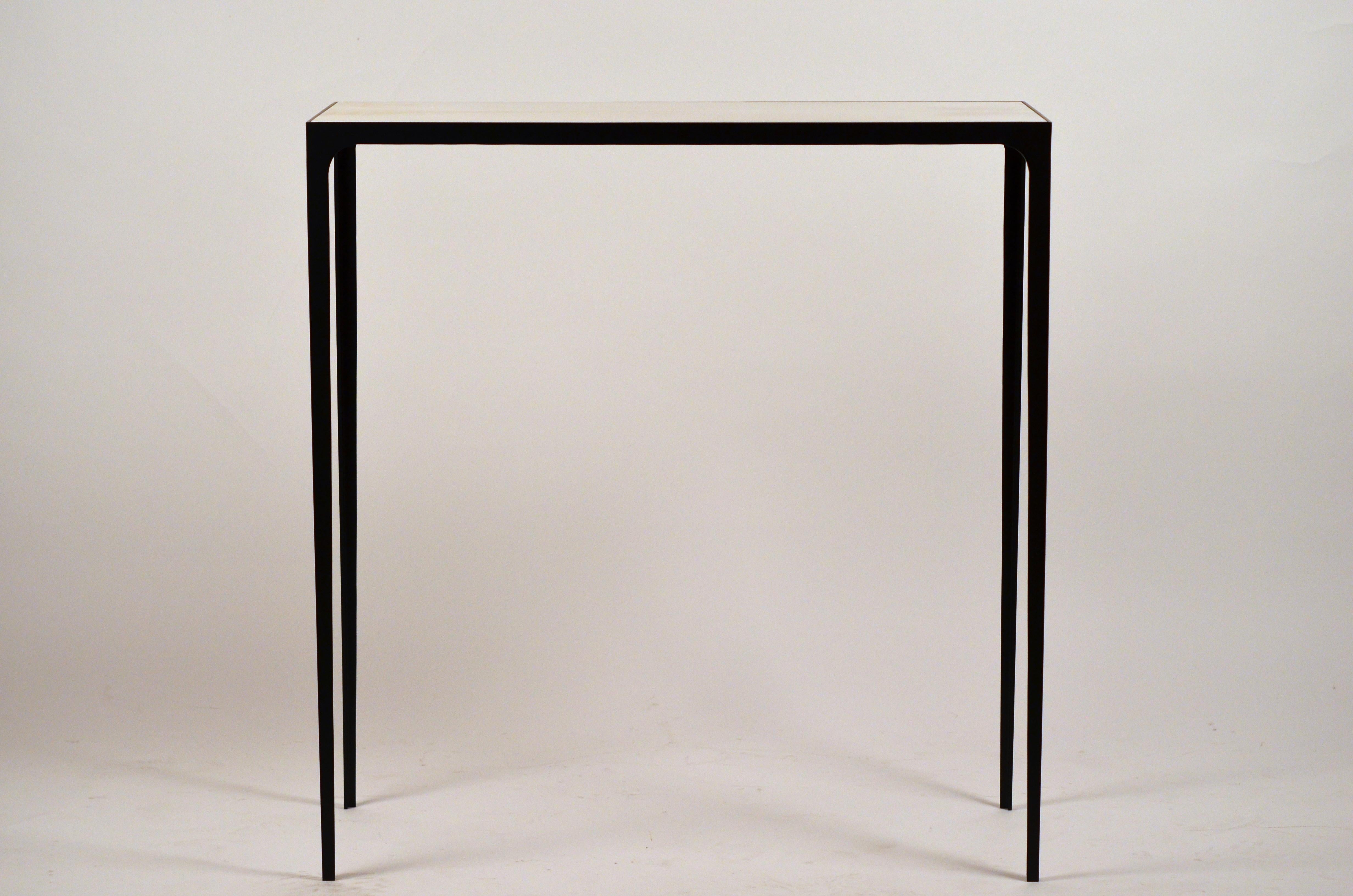 Chic 'Esquisse' wrought Iron and ivory parchment console by Design Frères. Contrasting ivory goat parchment top over slender blackened steel base. Beautifully simple, understated design.