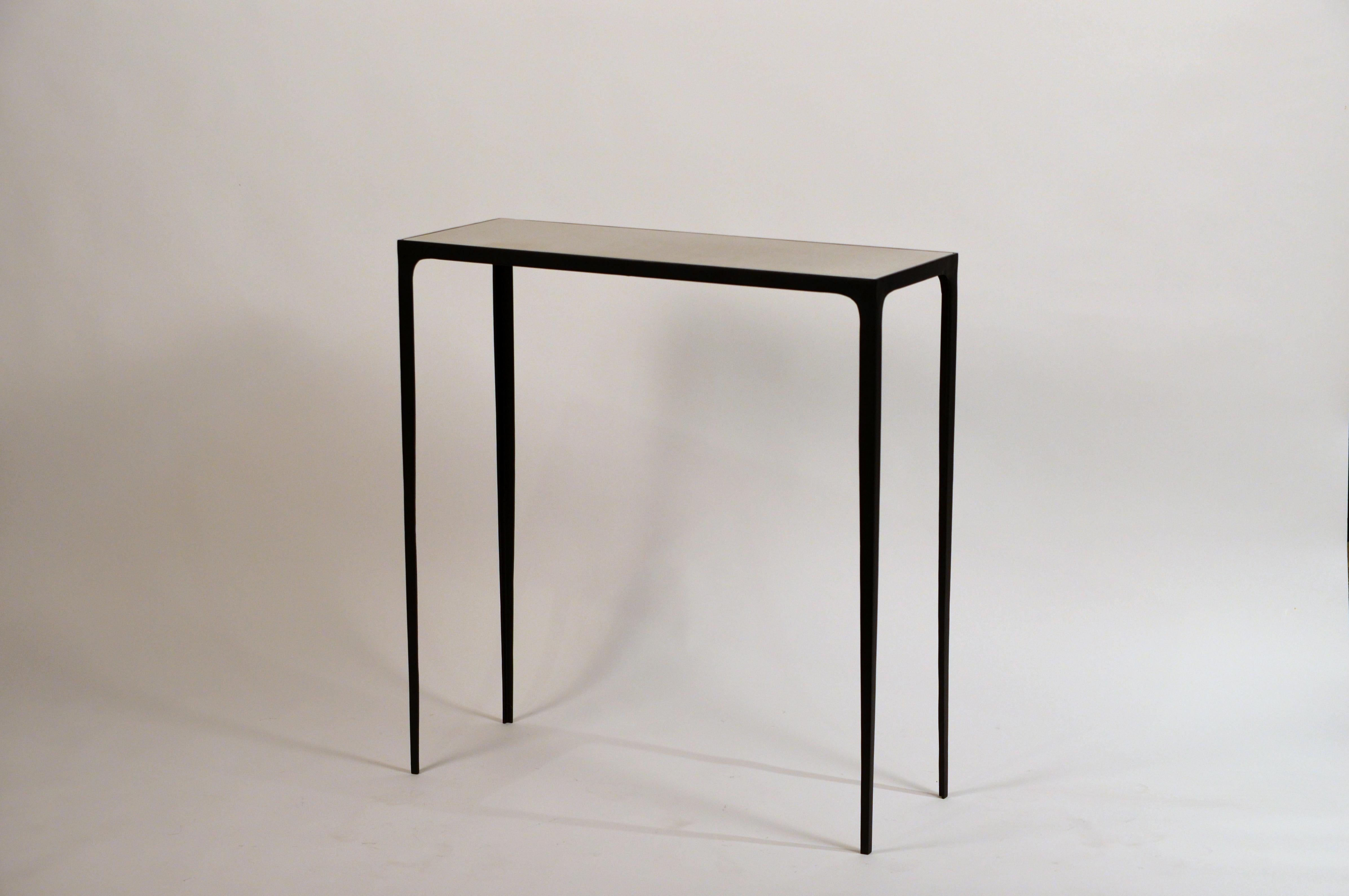 Understated 'Esquisse' wrought iron and parchment console by Design Frères. Chic parchment top fitted onto a slender matte black wrought iron base.