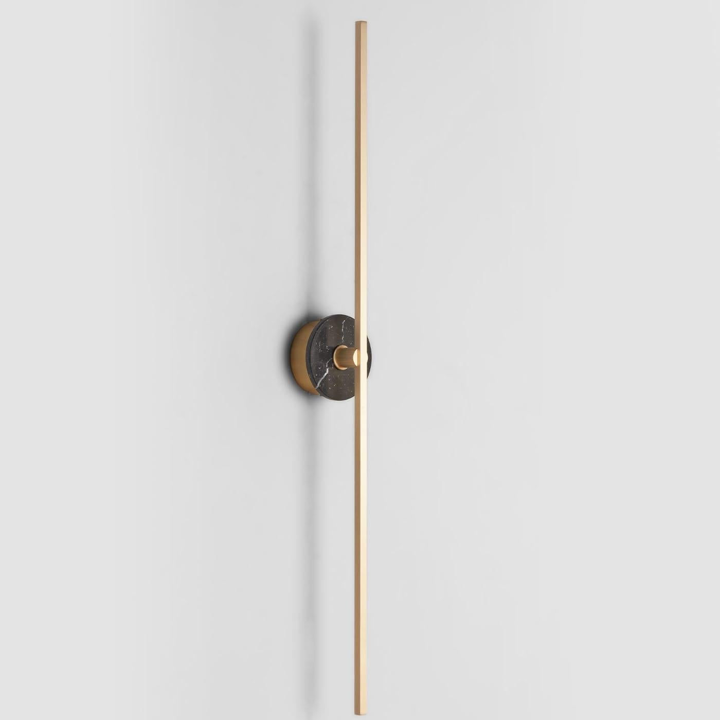 The Grand stick wall sconce is a contemporary lighting fixture that features a Minimalist design with thin brass profiles and advanced LED technology. It emits a warm and diffused light that adds a cozy and inviting atmosphere to any room. The black