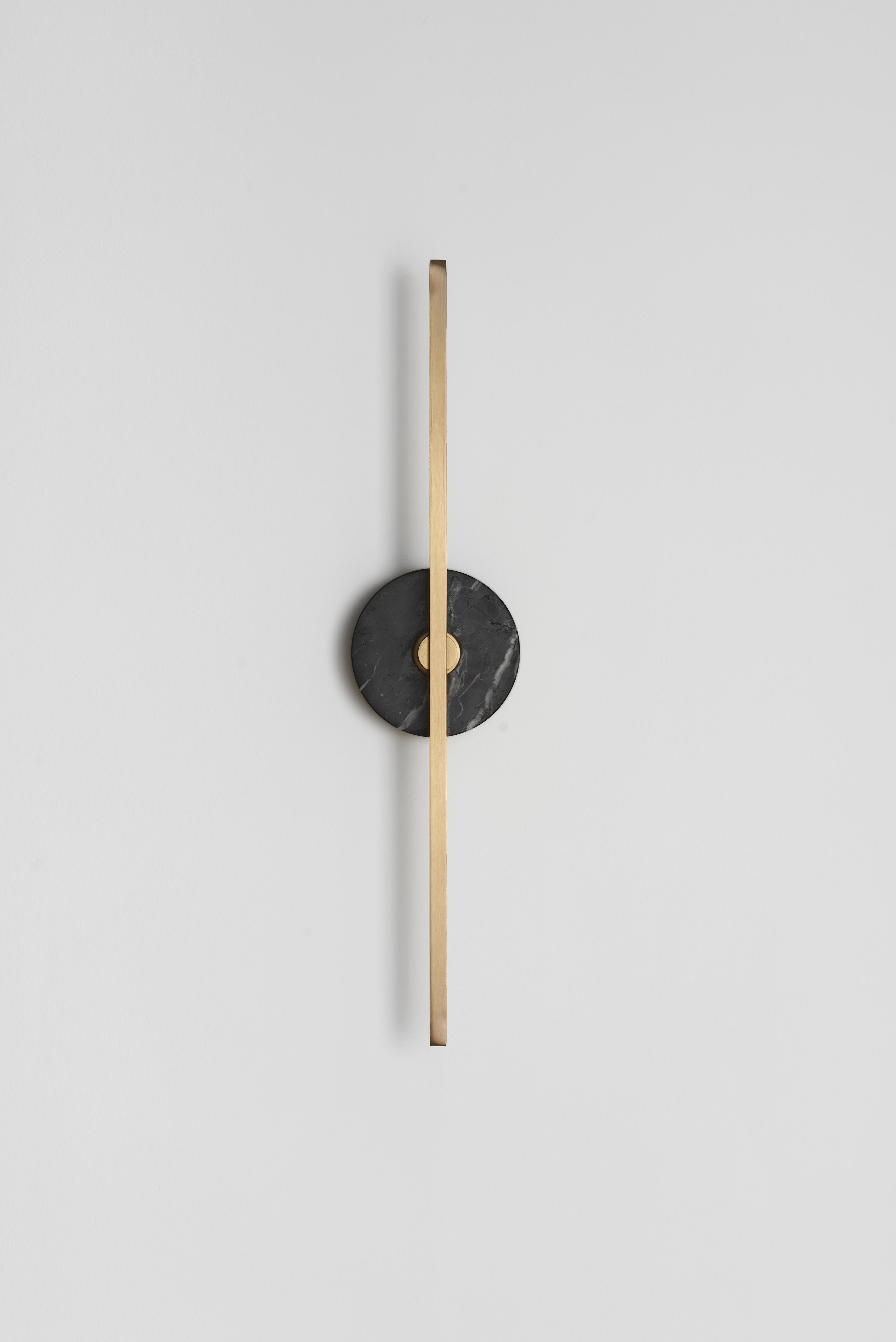 The stick wall sconce is a contemporary lighting fixture that features a Minimalist design with thin brass profiles and advanced LED technology. It emits a warm and diffused light that adds a cozy and inviting atmosphere to any room.

The black
