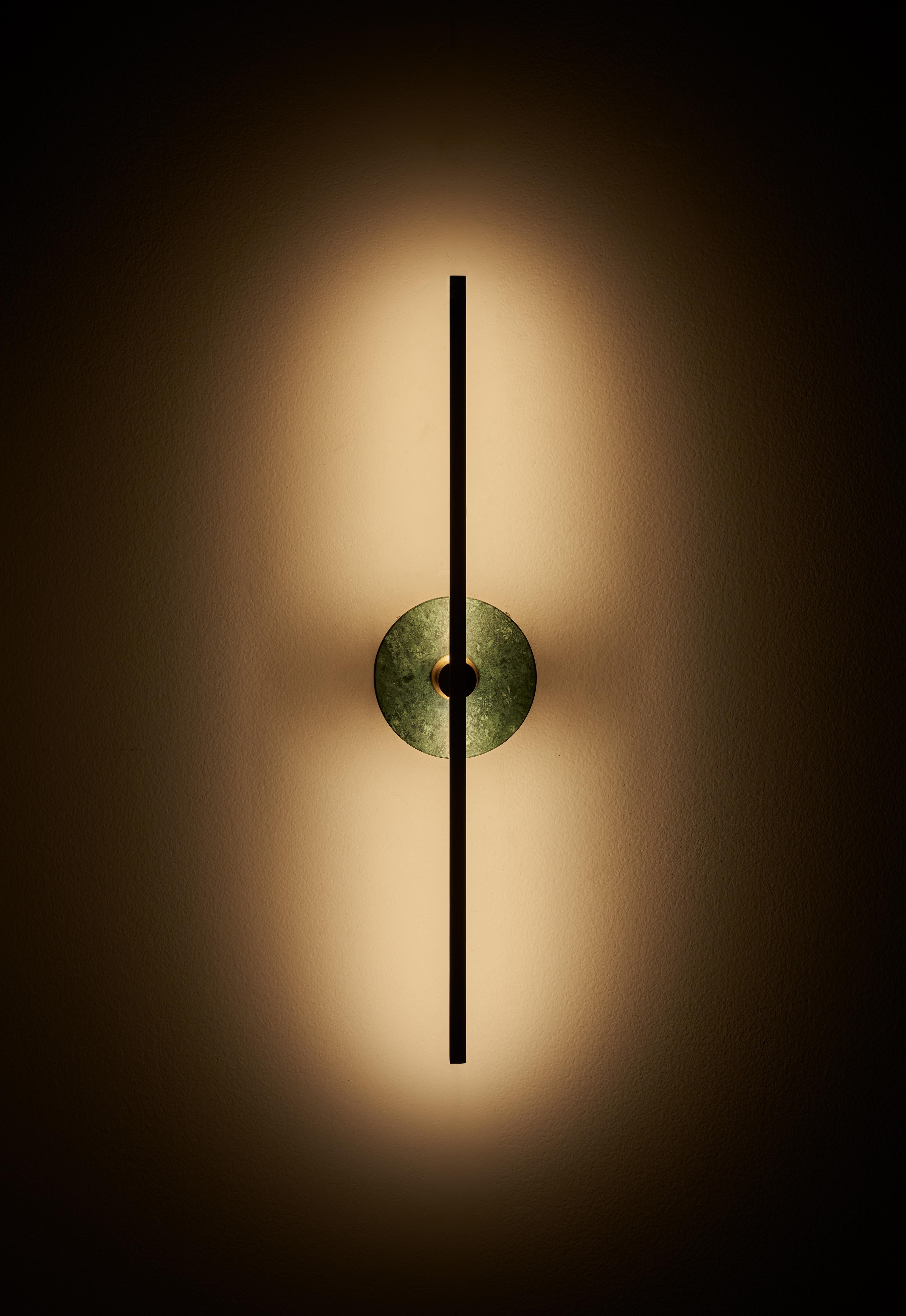 The stick wall sconce is a contemporary lighting fixture that features a Minimalist design with thin brass profiles and advanced LED technology. It emits a warm and diffused light that adds a cozy and inviting atmosphere to any room.

The green