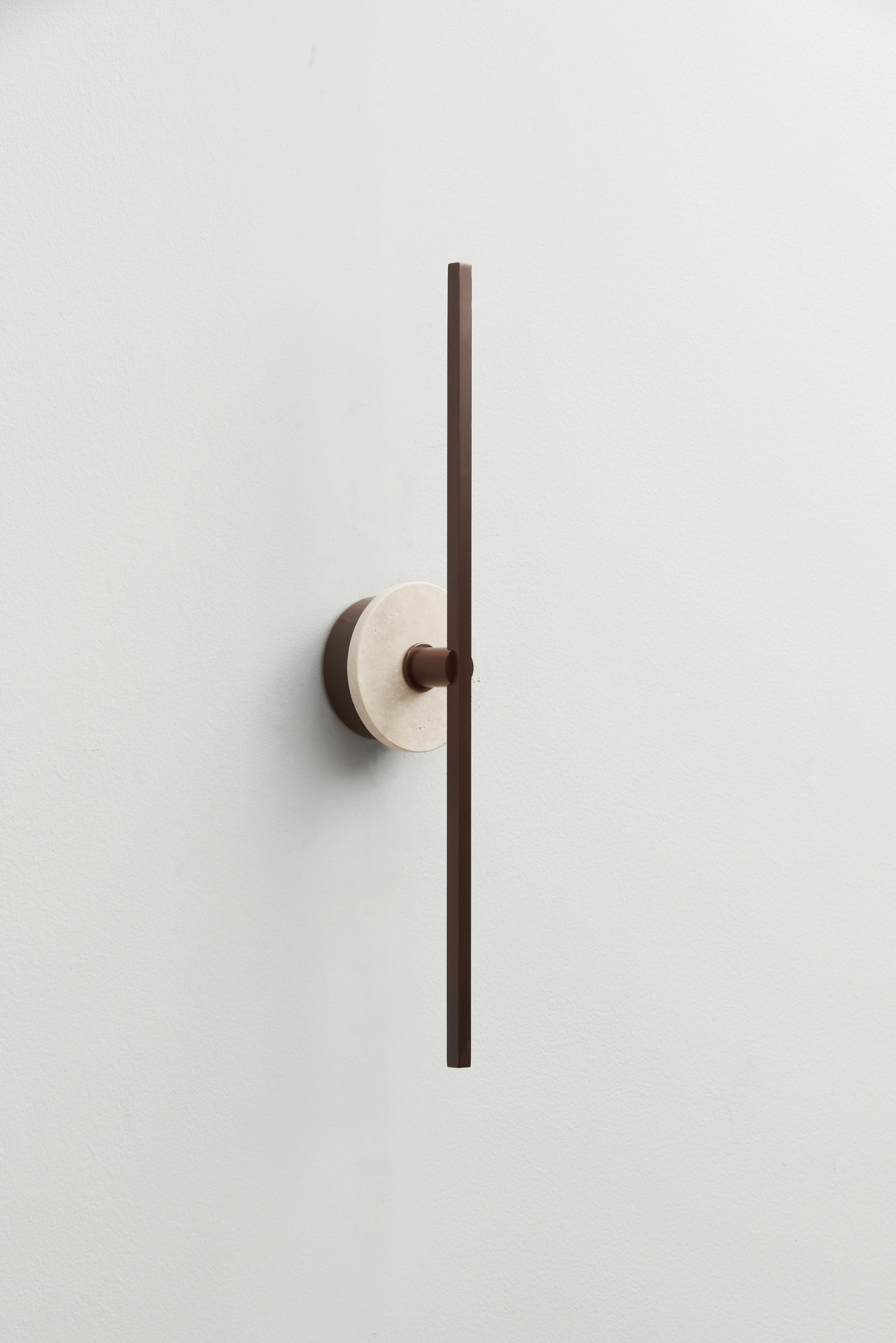 The Stick wall sconce is a visually appealing lighting fixture that combines modern design elements with efficient lighting technology. Its thin bronze profiles and utilization of LED technology contribute to a minimalist aesthetic, making it an