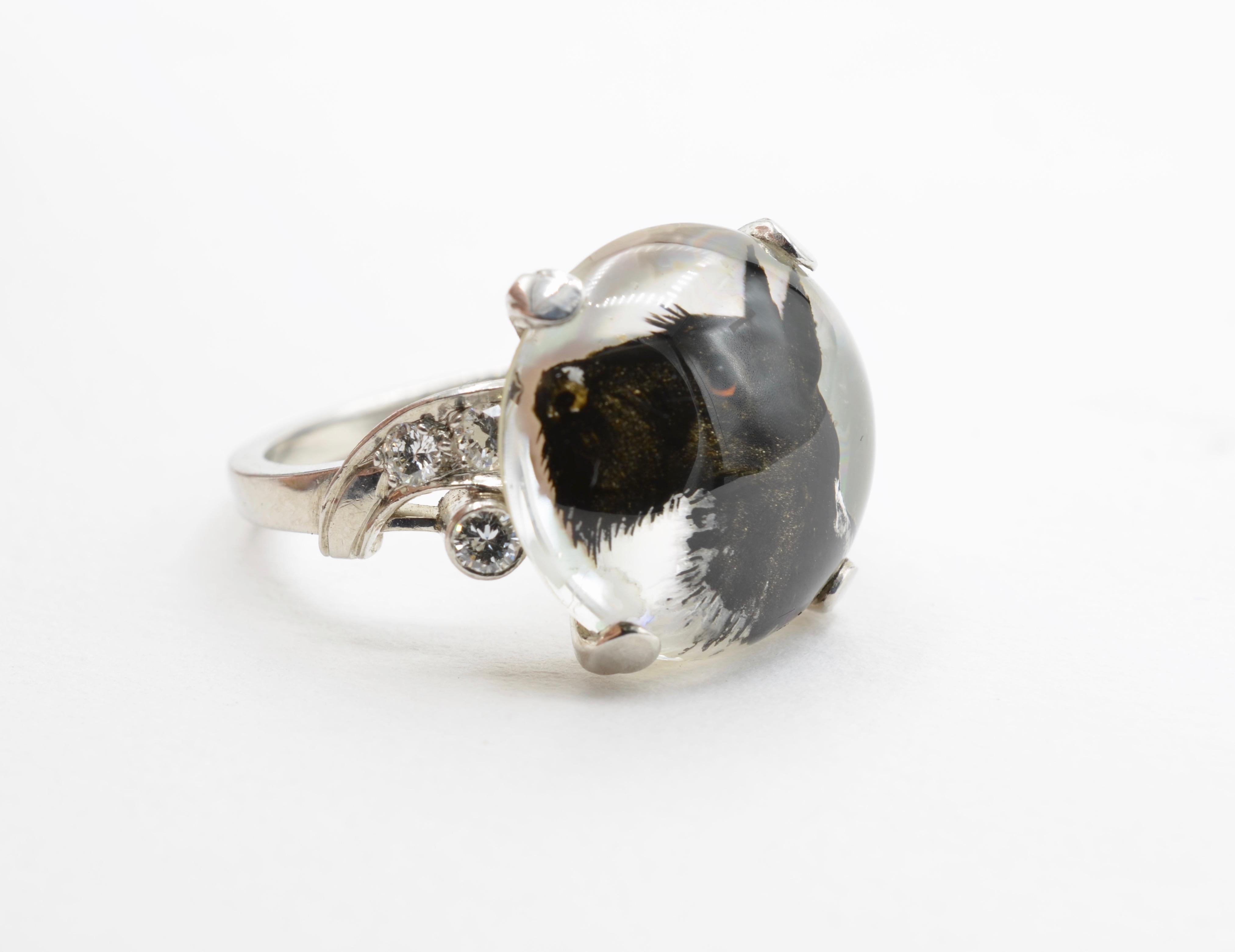 The intricate detail of this hand painted  reverse intaglio Scottie dog shows cute little ears, a nose, and bright eyes. Set in platinum 900 with Iridium 100, this ring transforms into elegance with 6 round accent diamonds and a total weight of 0.20