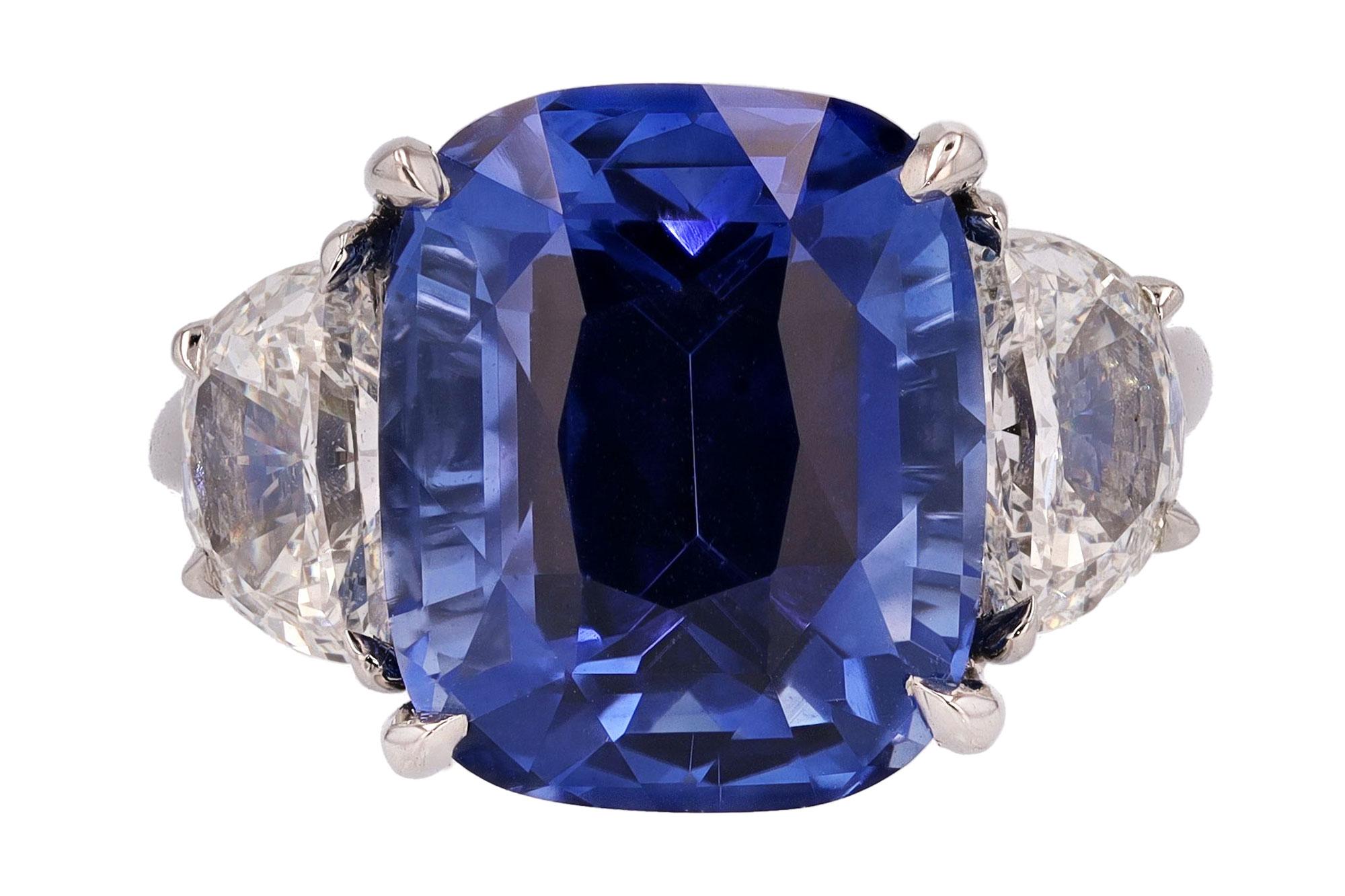 An important 10 carat sapphire engagement ring boasting a most desirable, open and tranquil crystal blue color. A rare, natural specimen certified by the prestigious Swiss GRS laboratory. The platinum mount flanked by a pair of 1.40 carats of
