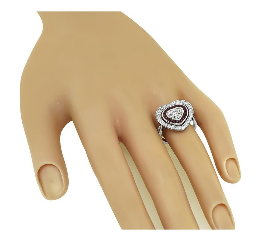 This is a gorgeous platinum heart ring. The ring is centered with sparkling heart shape diamond that weighs approximately 1.00ct. The color of the diamond is H with SI2 clarity. The center diamond is accentuated by sparkling round cut diamonds and