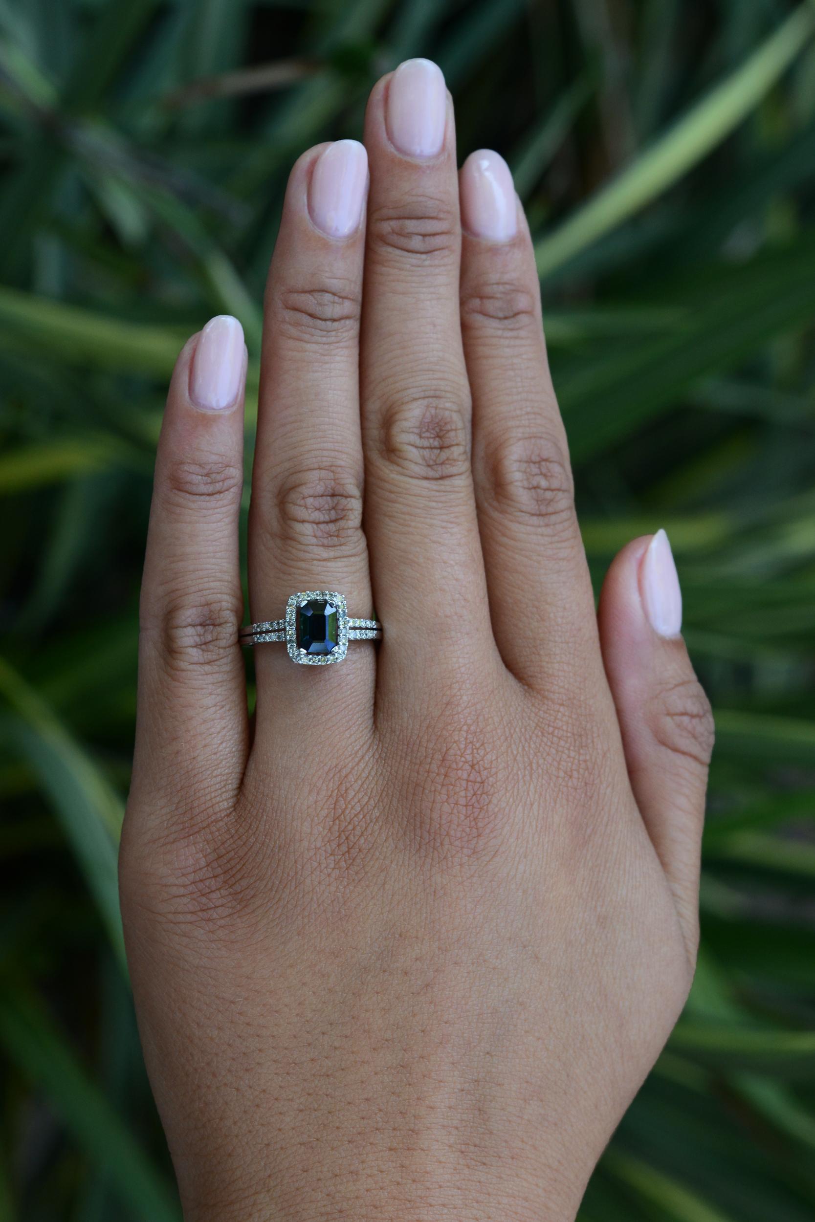 This contemporary classic estate engagement ring has a big personality and a small price. The vintage gemstone bridal ring holds a deep night blue sapphire weighing a prominent 1.15 carats. The silky sapphire is enveloped in a modern split shank