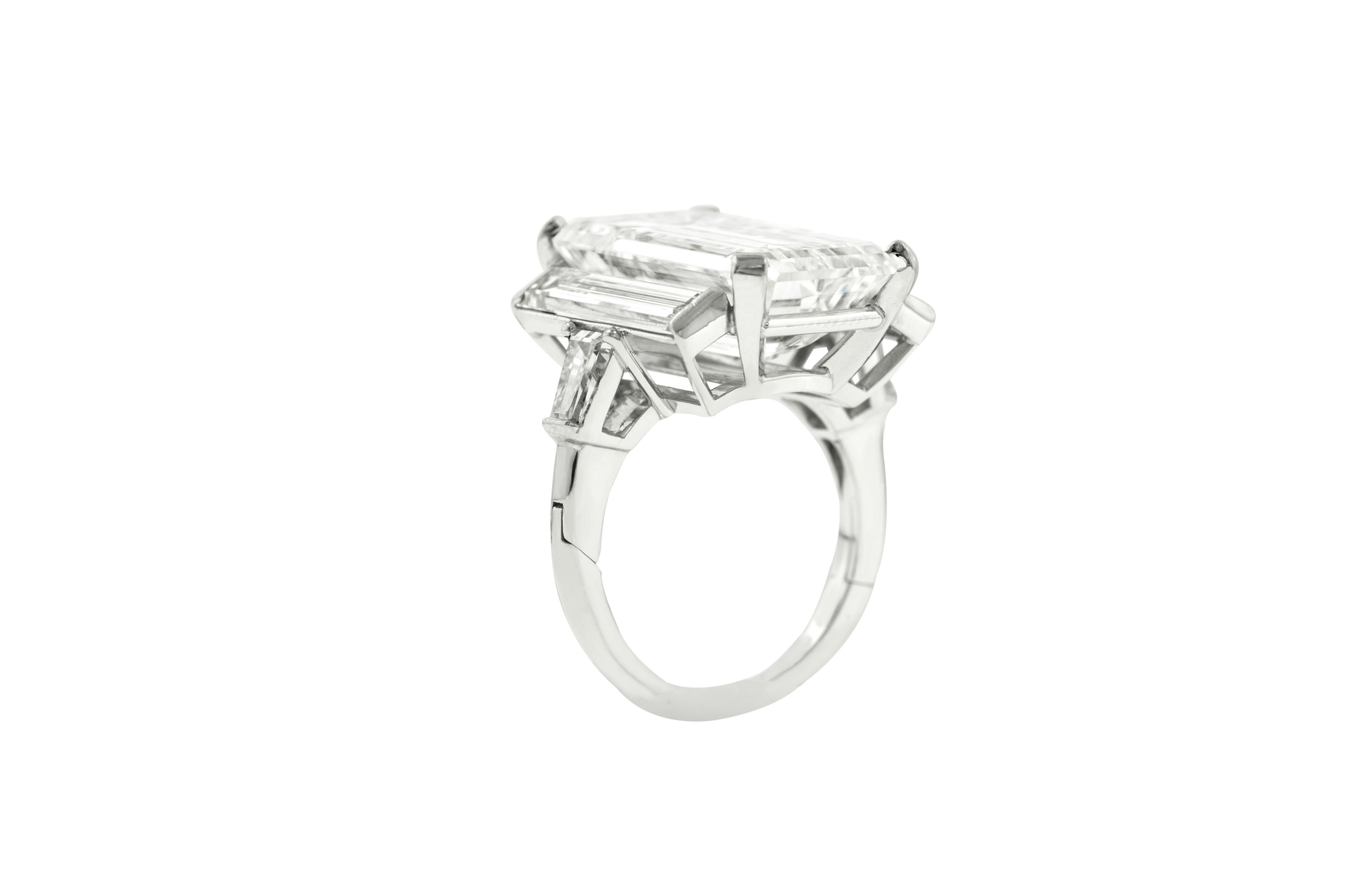 Estate Platinum Emerald cut three stone diamond ring. The center stone is  12.85 Carats Emerald Cut, ideal shape, J in color VS2 in Clarity certified by EGL, set with two long baguette diamonds totaling 2.50 Carats of diamonds. 
Remarkable Three