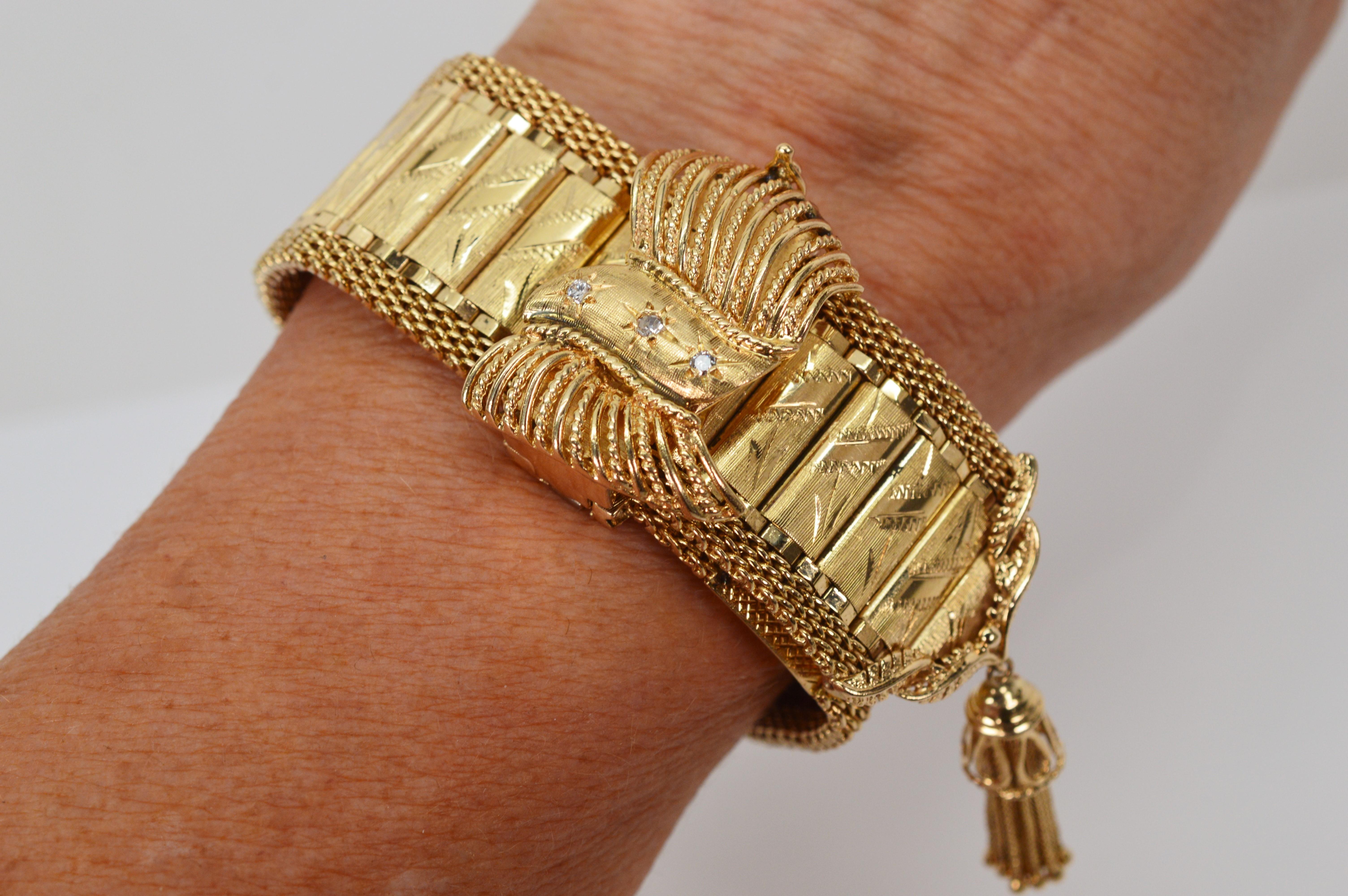 Victorian style appointments and a concealed timepiece give this gorgeous vintage 14 Karat Yellow Gold Wrap Style Bracelet  its stunning high style.
Framed with a rounded gold mesh detail along its generous 9 inch length, individual engraved gold