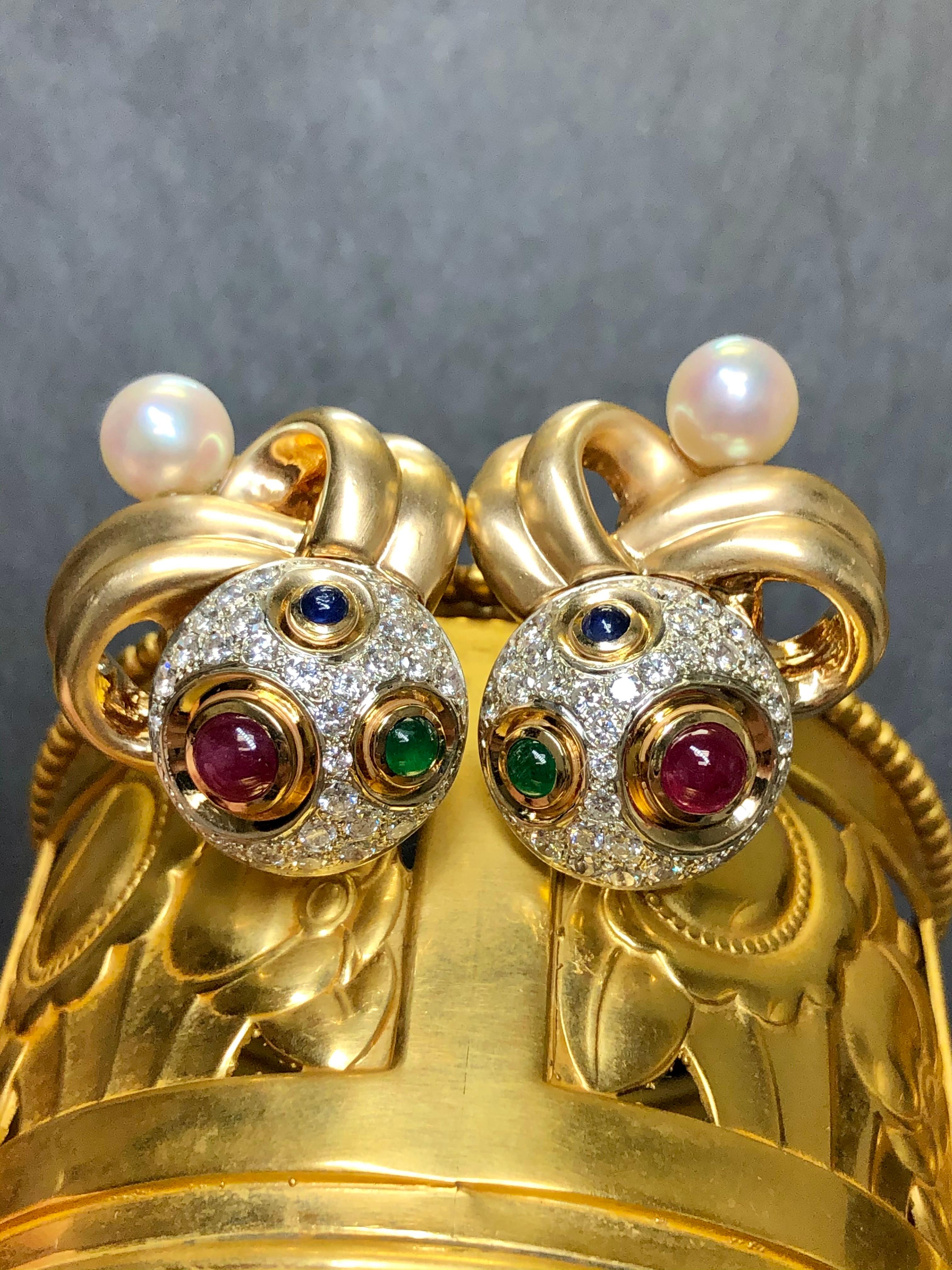 
A beautiful and unique pair of earrings hand crafted in 14K satin finished and high polished yellow gold set with approximately 2cttw in G-I color Vs1-2 clarity round diamonds as well as approximately 1cttw cabochon sapphires, 1.50cttw in cabochon
