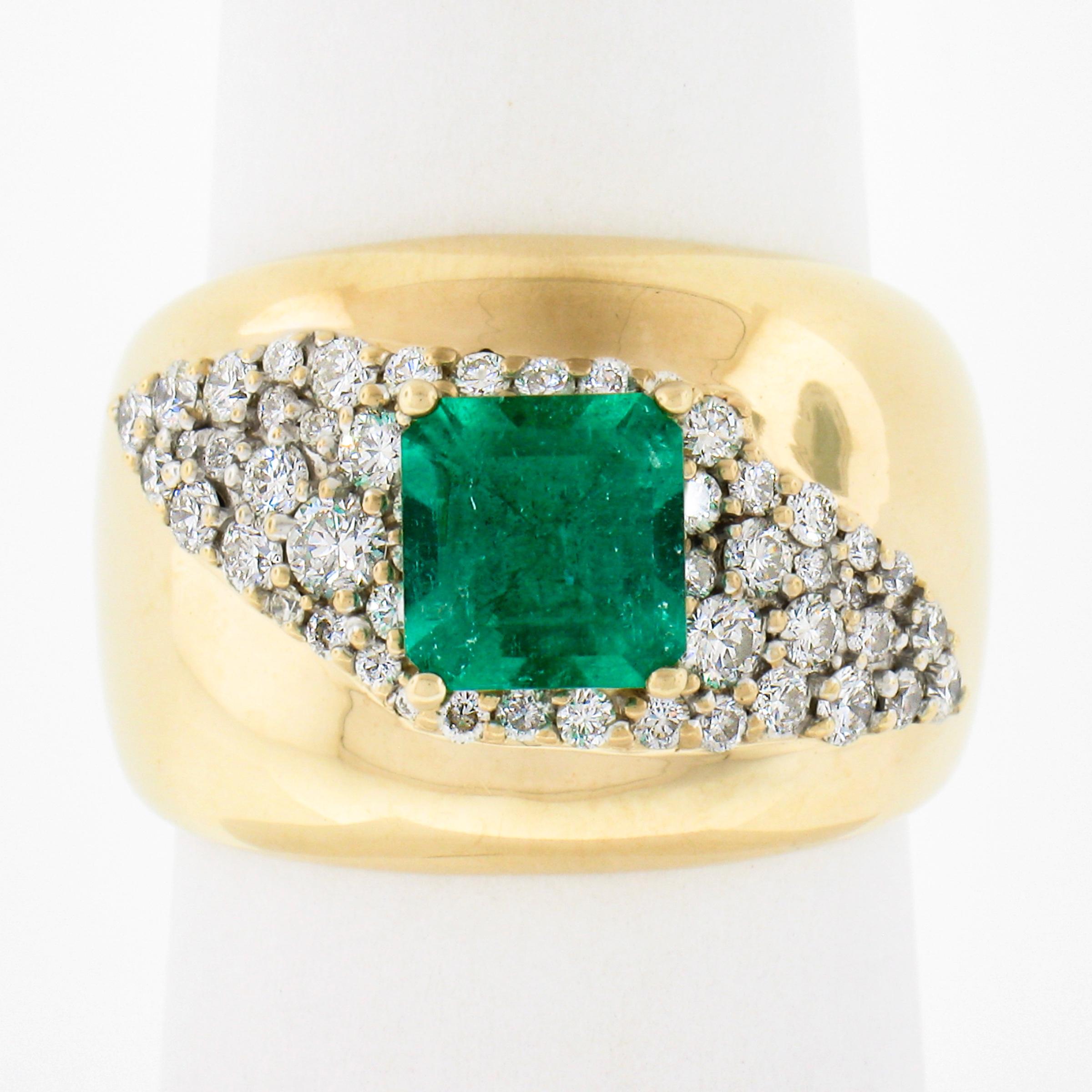This unique and elegant cigar band ring is crafted in solid 14k yellow gold and features a smooth dome top set with a magnificent natural emerald stone that's further adorned with a diagonal design of pave set diamonds throughout. The emerald is a