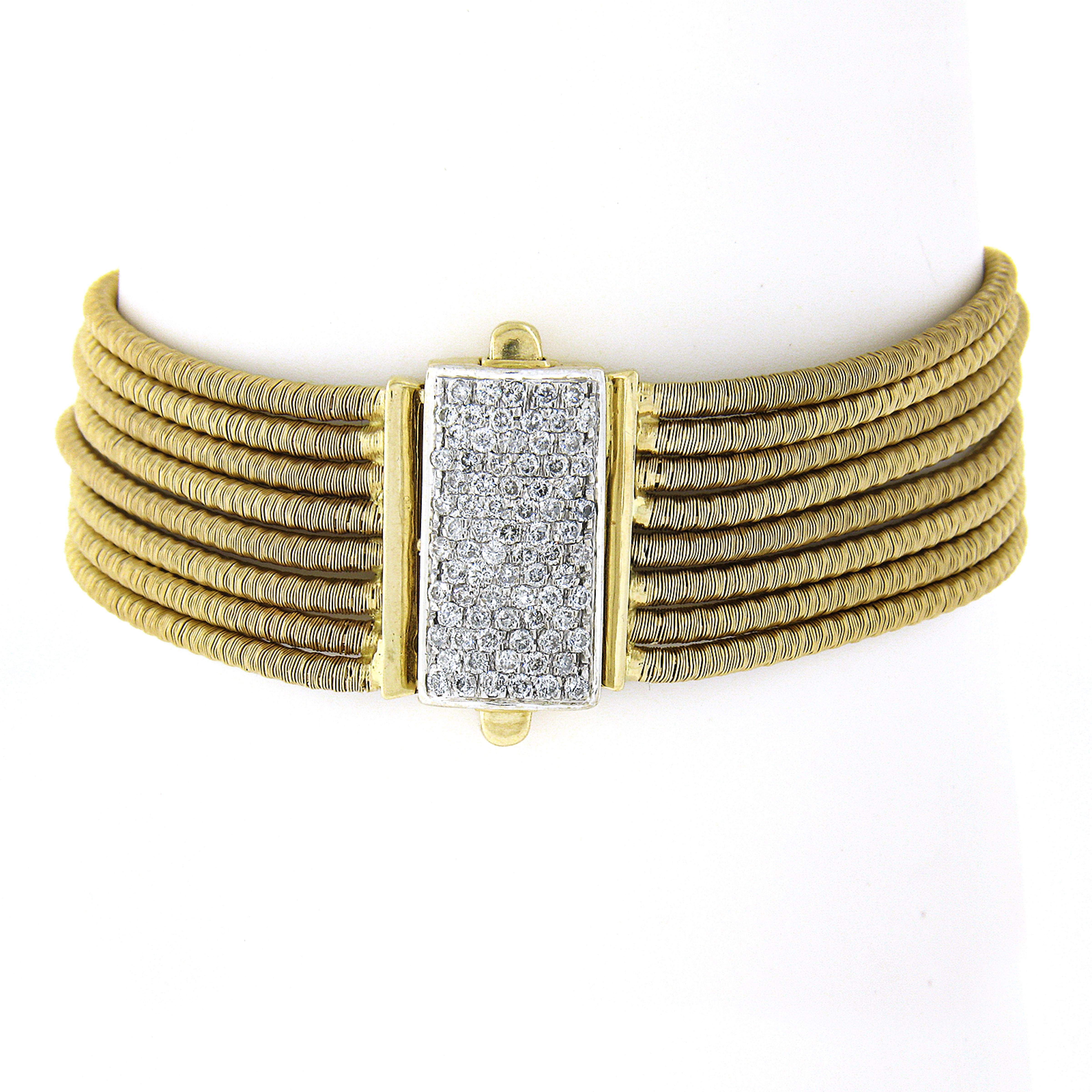 Here we have a beautiful multi strand gold bracelet crafted in solid 14k yellow gold. It feature very fine and well done coiled gold wire that wraps around each strand and offers soft silky feel around the wrist. The clasp is fully encrusted with