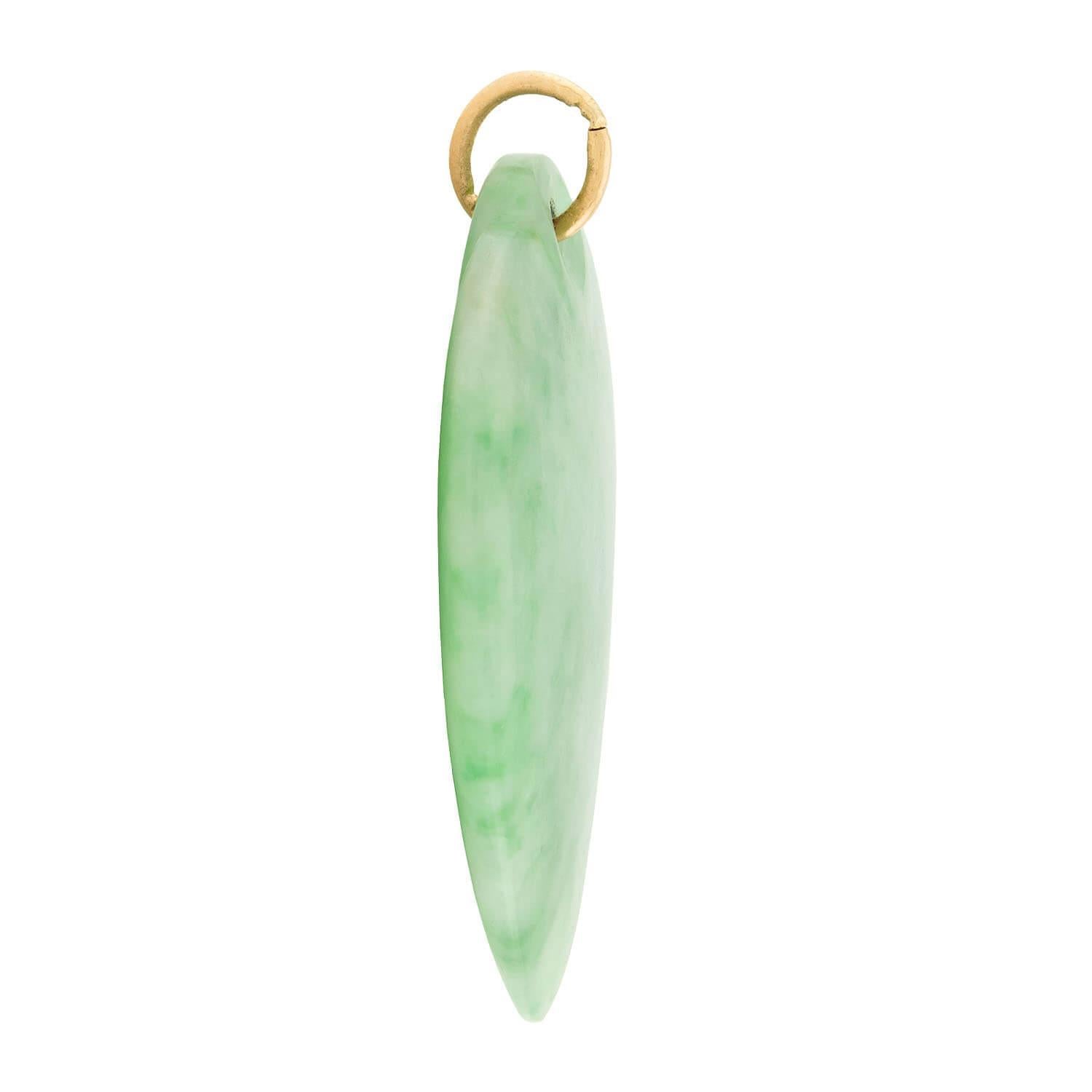 A beautiful jade pendant! This romantic piece is comprised of a heart-shaped piece of jade. The jade displays a lovely mixture of luscious green hues and milky white marbling. The top of the heart features a small hole, through which a 14k gold bail