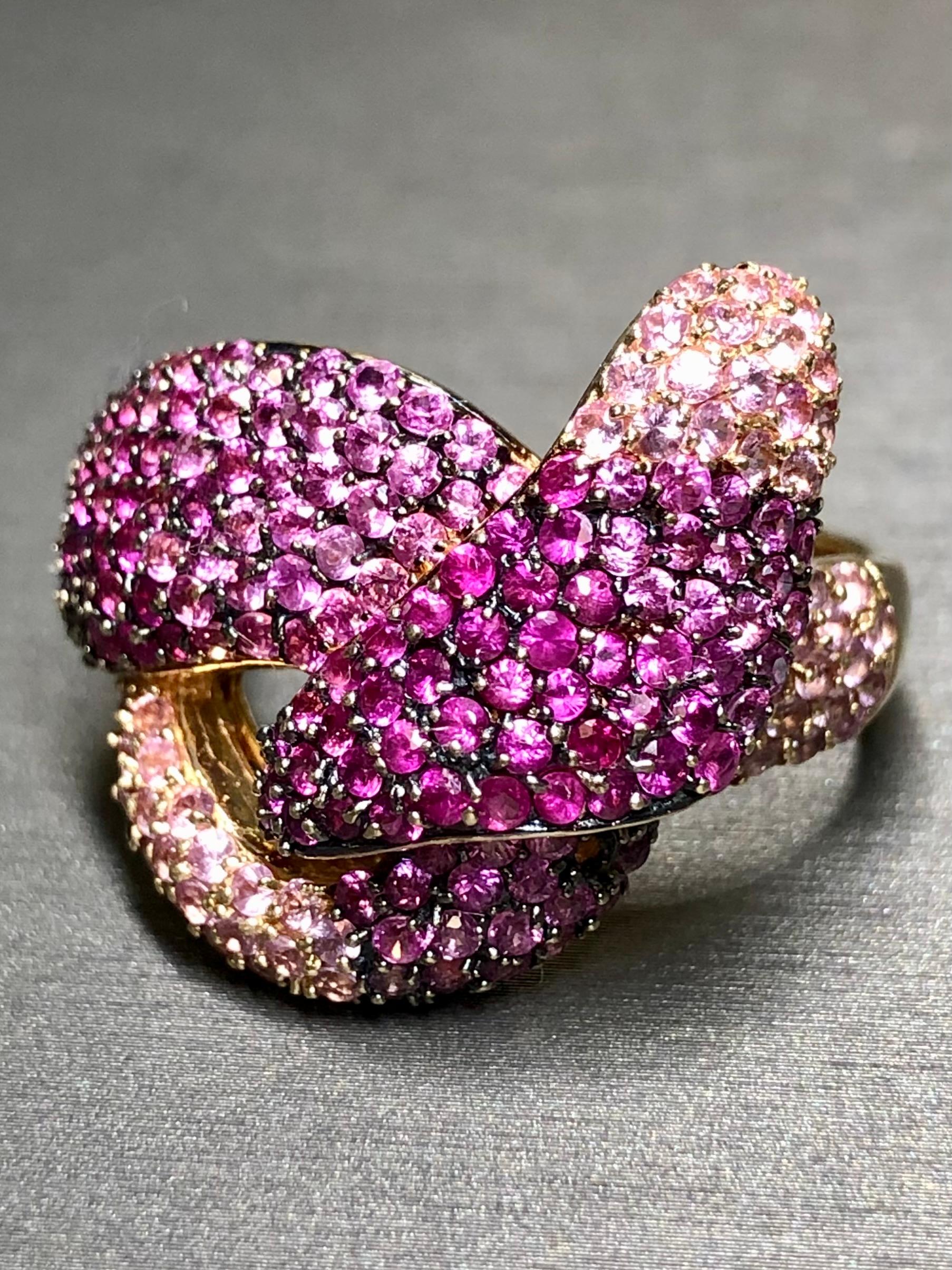 
A dazzling cocktail ring done in 14K rose gold by EFFY. It has been pavè set with approximately 8cttw in various toned natural pink sapphires and bold knot or twist design.


Dimensions/Weight:

Ring measures 1” top to bottom and weighs 12.6g. Size
