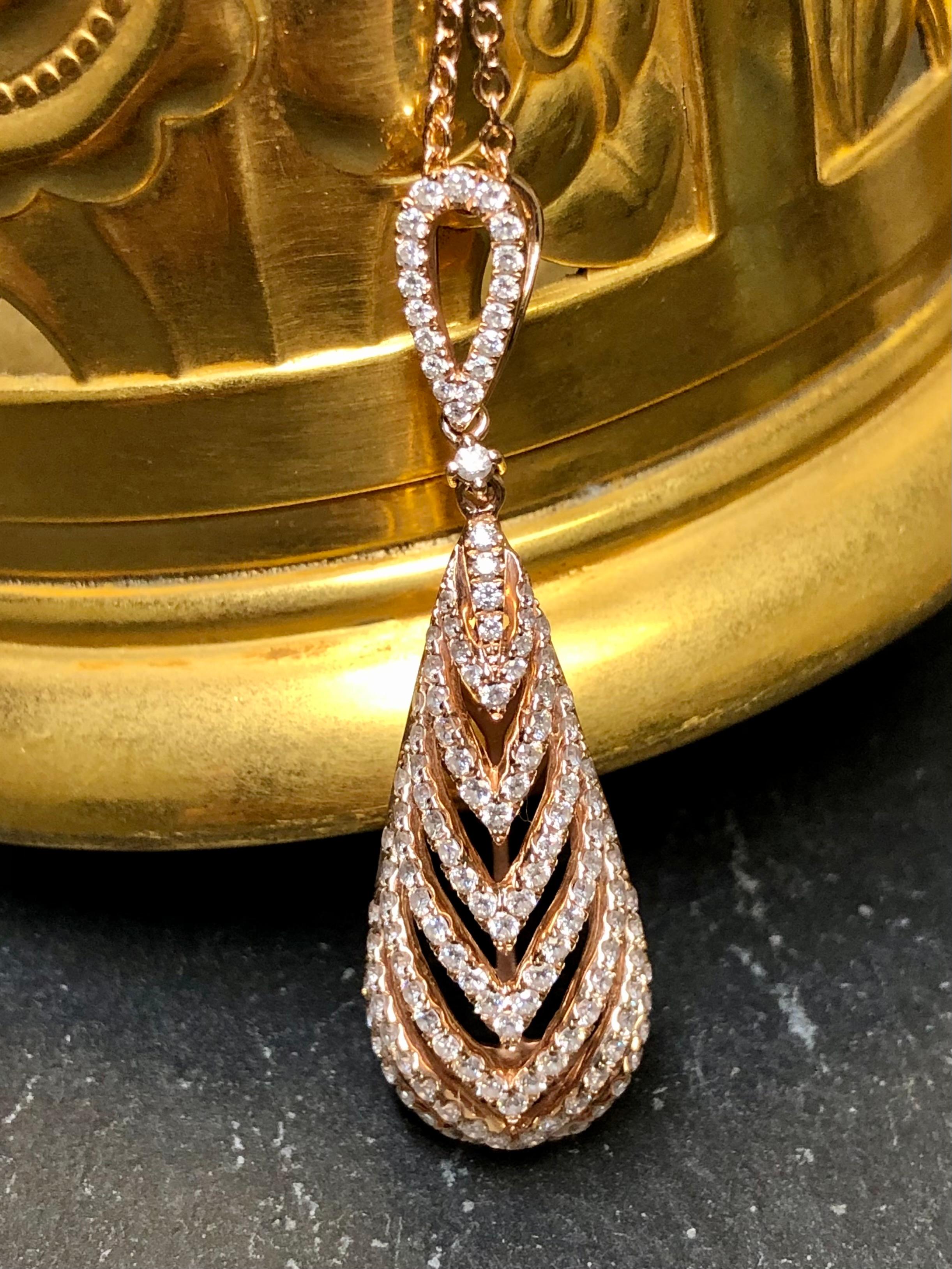 
A striking pendant done in 14K rose gold set with approximately 1.85cttw in G-I color Vs2-Si1 clarity round diamonds. The chain that accompanies it is a “diamonds-by-the-yard” style and can be worn at 16”, 17” or 18”