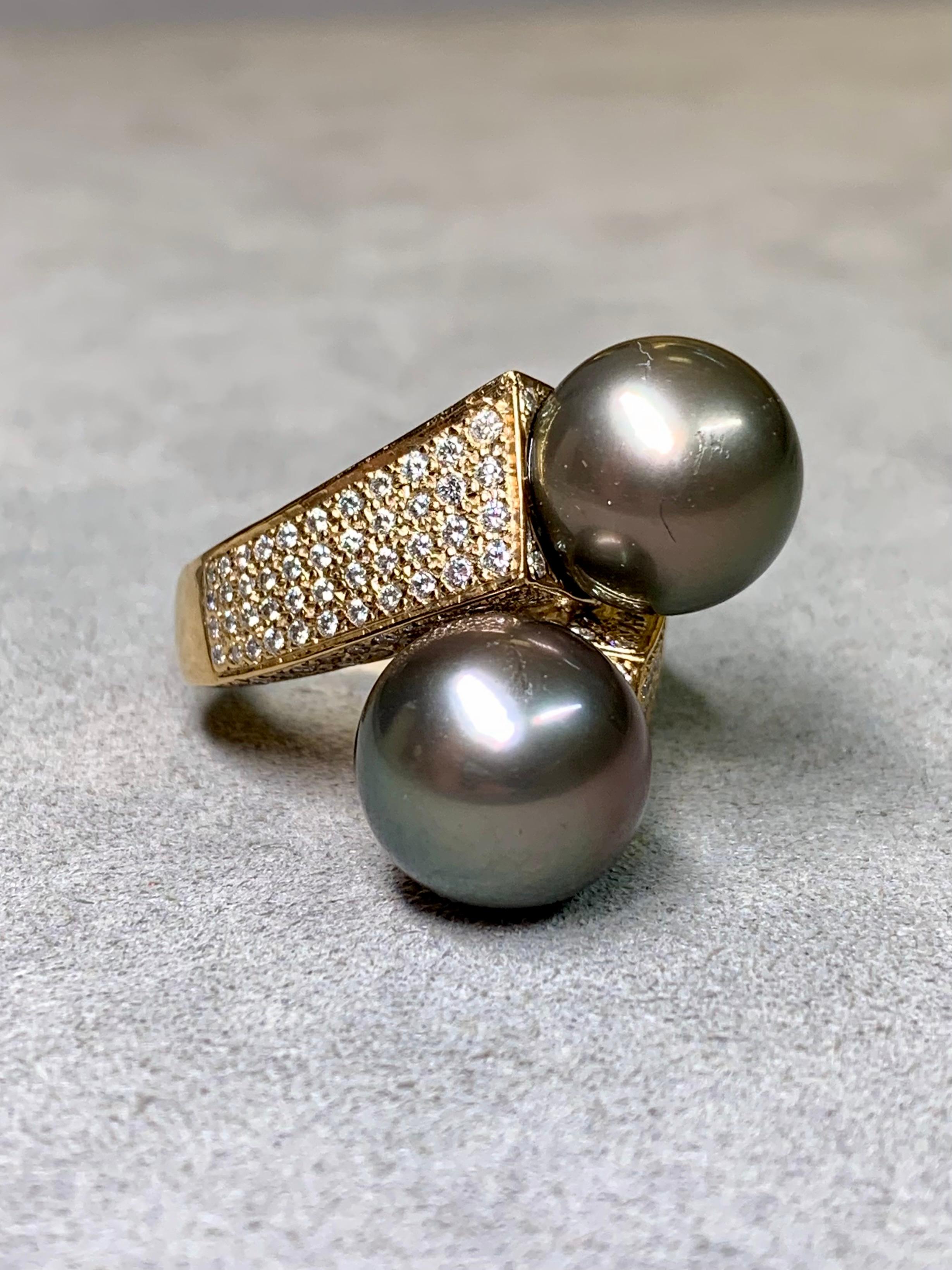 This bold estate bypass cocktail ring is a statement of both luxury and craftsmanship. Handcrafted in 14 karat yellow gold, it is topped with two lustrous Tahitian South Sea pearls measuring an impressive average of 12.30 mm each. Both pearls