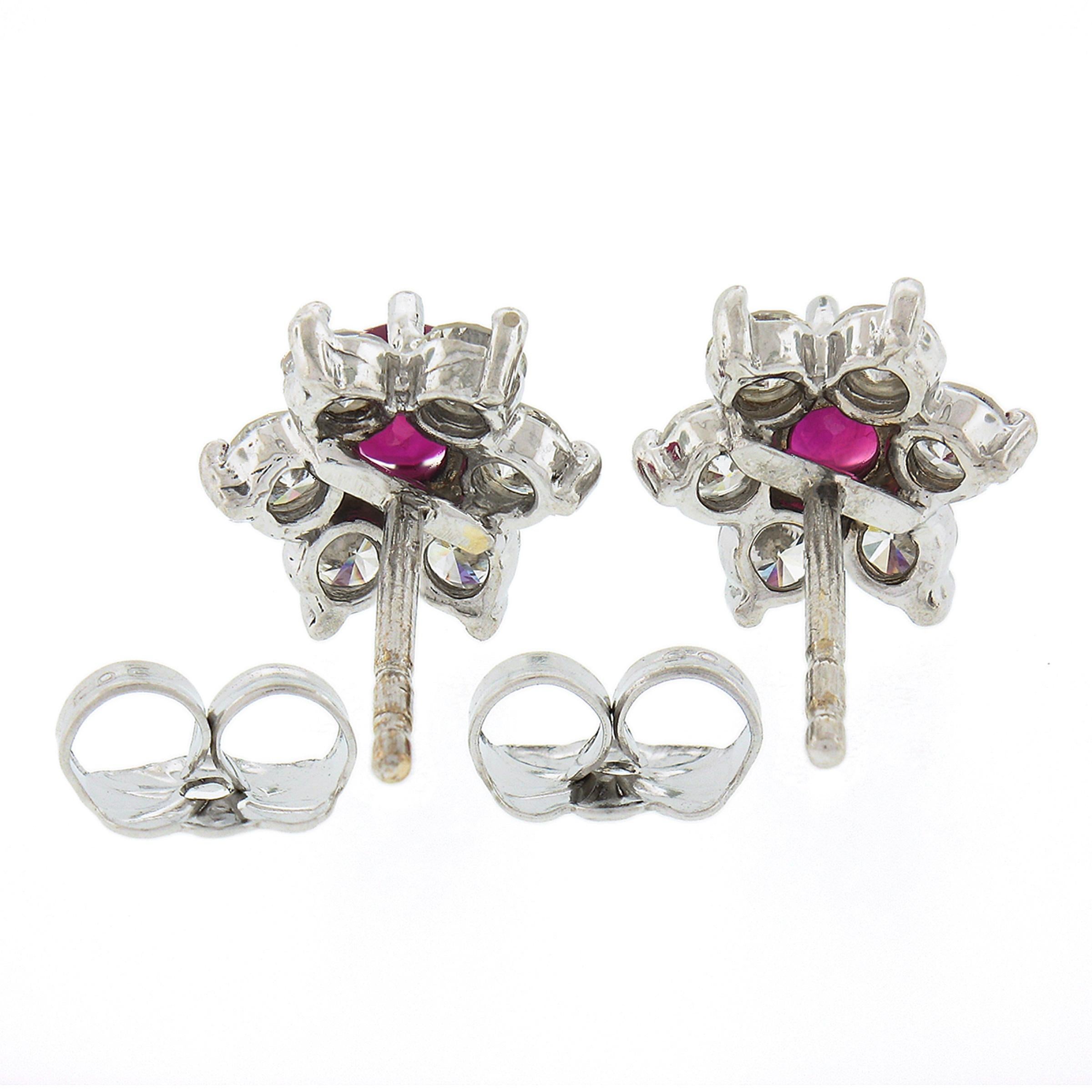This is an absolutely gorgeous petite pair of ruby and diamond flower cluster earrings that is very well crafted in solid 14k white gold. Each earring features a fine round brilliant ruby neatly set at its center showing the most stunning vivid