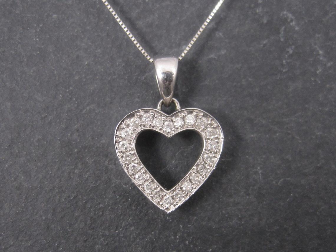 This gorgeous necklace is comprised of 14k white gold.

The pendant measures 5/8ths of an inch by 5/8ths of an inch, not including the bail.
It features .25 ctw in 22 round cut, natural diamonds.
These are very nice stones with lots of sparkle.
The
