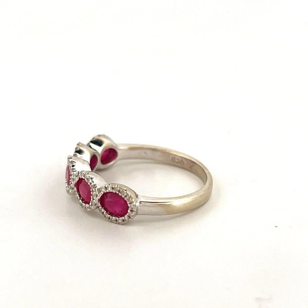 Offered here is a vibrant natural ruby and diamond band crafted in solid 14K white gold, stamped 