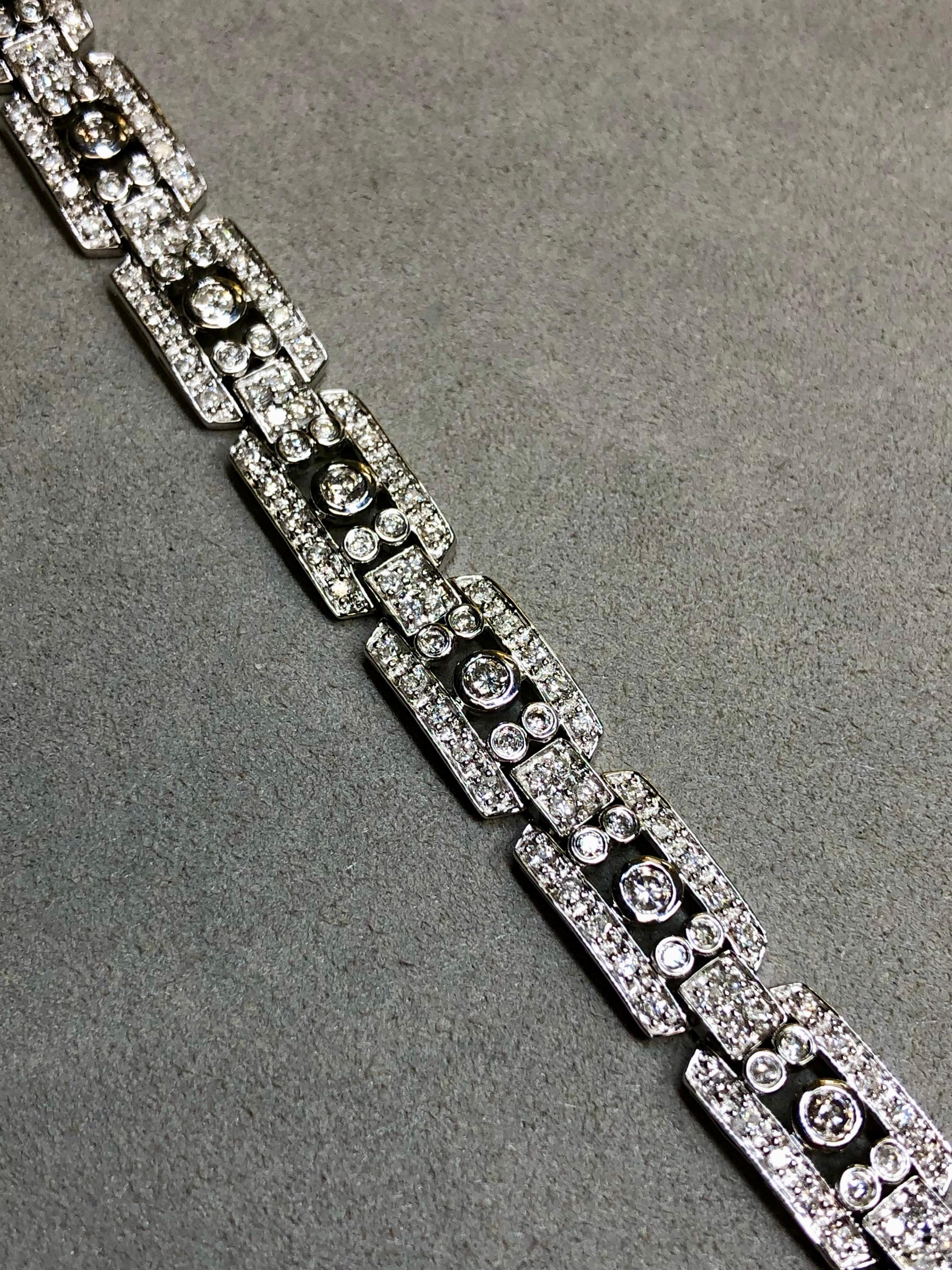 A show-stopping contemporary cocktail bracelet done in 14K white gold in the Art Deco style and both bead and bezel set with approximately 4.60ctw in round diamonds. All stones average H-I color and and Si1-I1 clarity.


Dimensions/Weight:

This