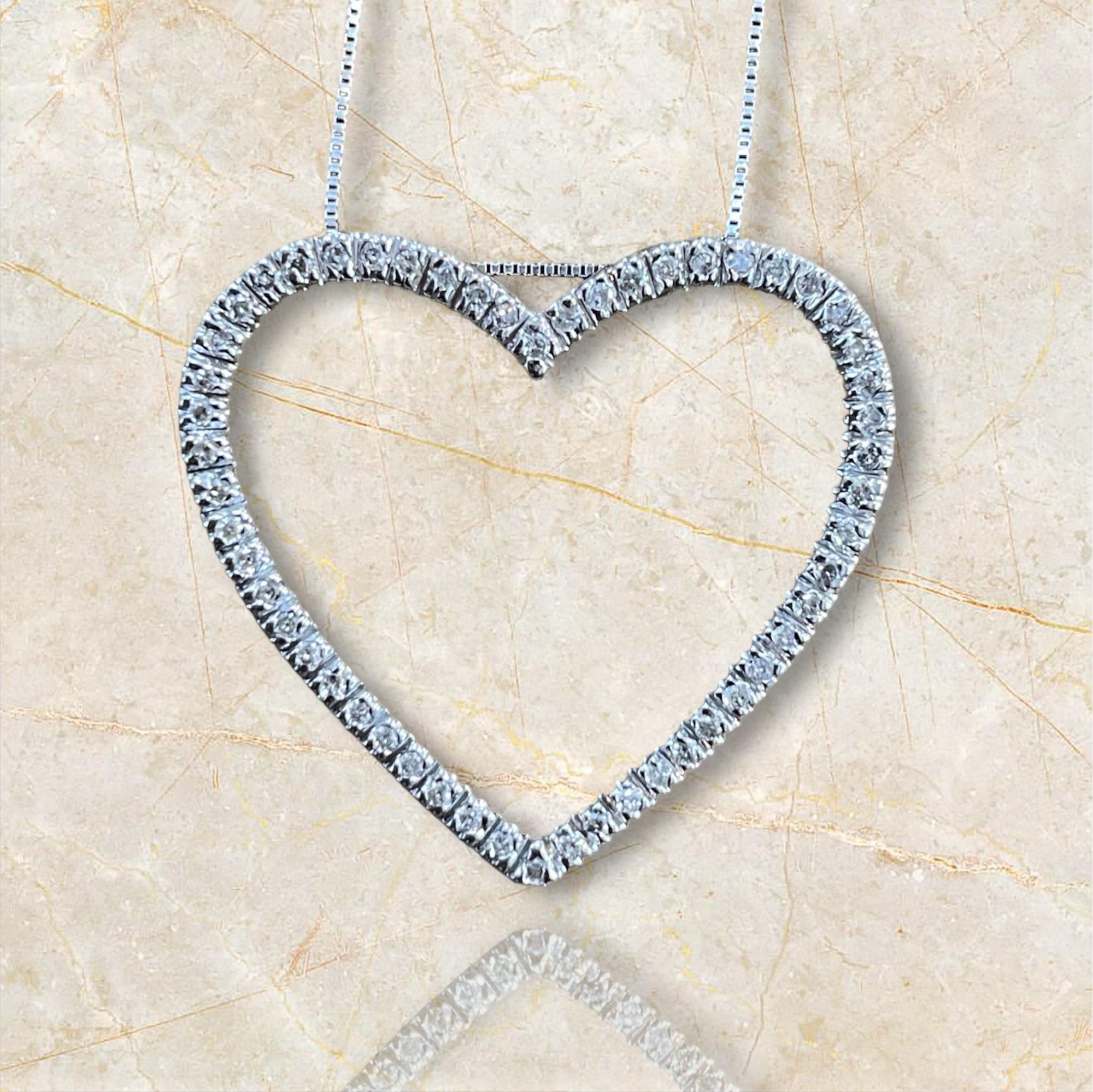 Embrace timeless romance with this estate 14K White Gold Diamond Heart Pendant Necklace. The elegant heart-shaped pendant is adorned with sparkling diamonds, creating a stunning display of brilliance and love. Perfect for any occasion, this