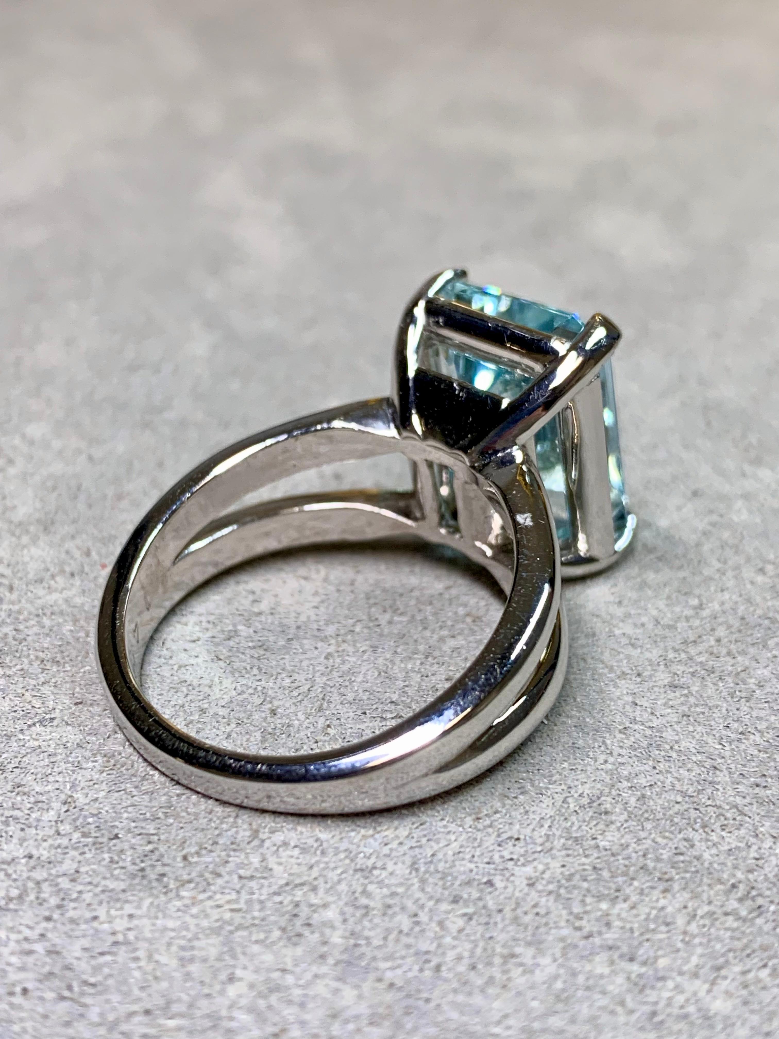 A bold and elegant estate cocktail ring, finely crafted in 14 karat white gold and centered by a substantial 10.17 carat natural aquamarine. The gem shows a beautiful medium blue hue and exceptional clarity, cut in an emerald shape that captures
