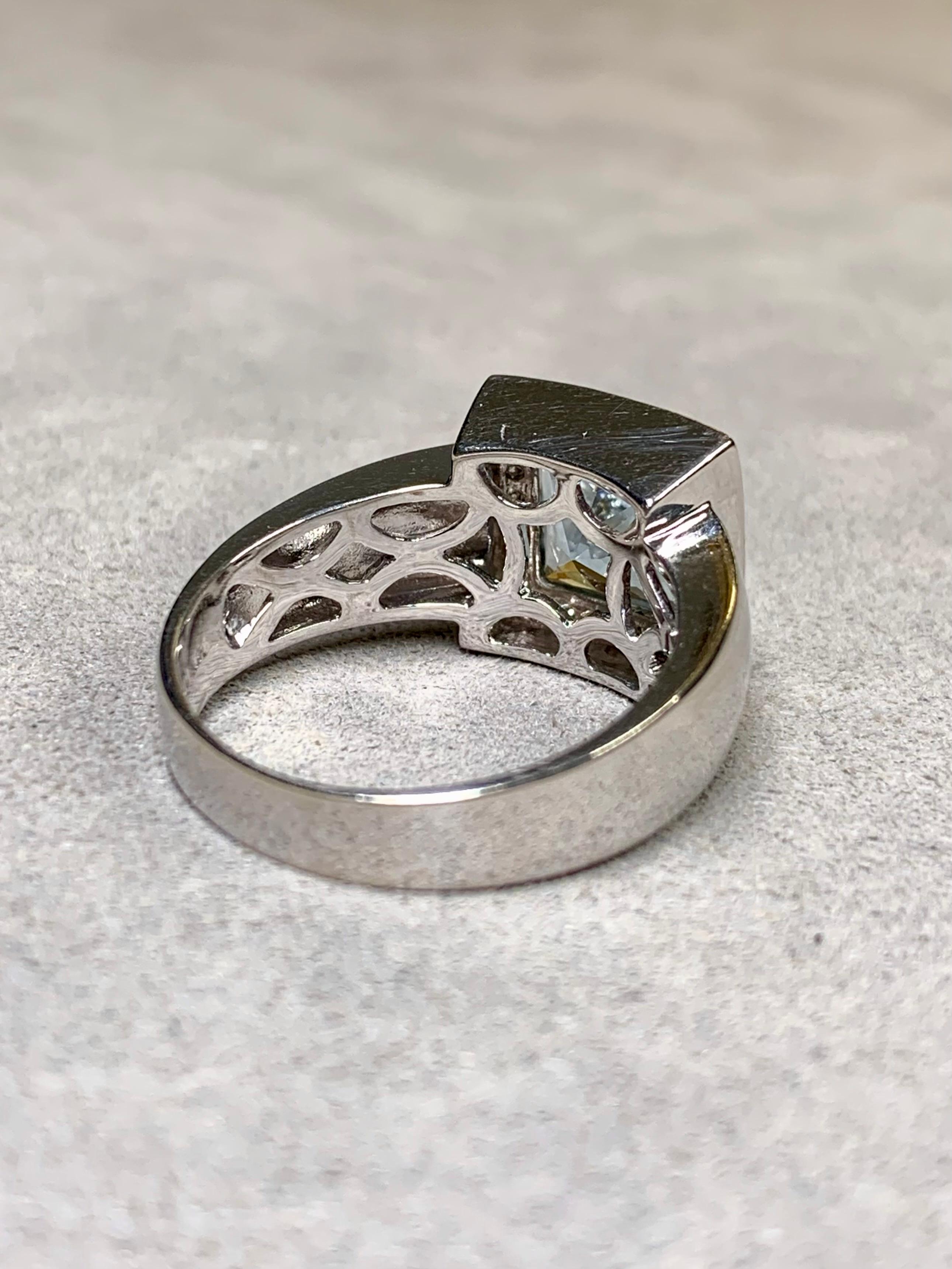 A contemporary ring done in 14K white gold and centered by a bezel set square cut natural aquamarine weighing approximately 2.40ct surrounded by approximately .32ctw in round cut H-I color Si1-2 clarity round diamonds.


Dimensions/Weight:

This