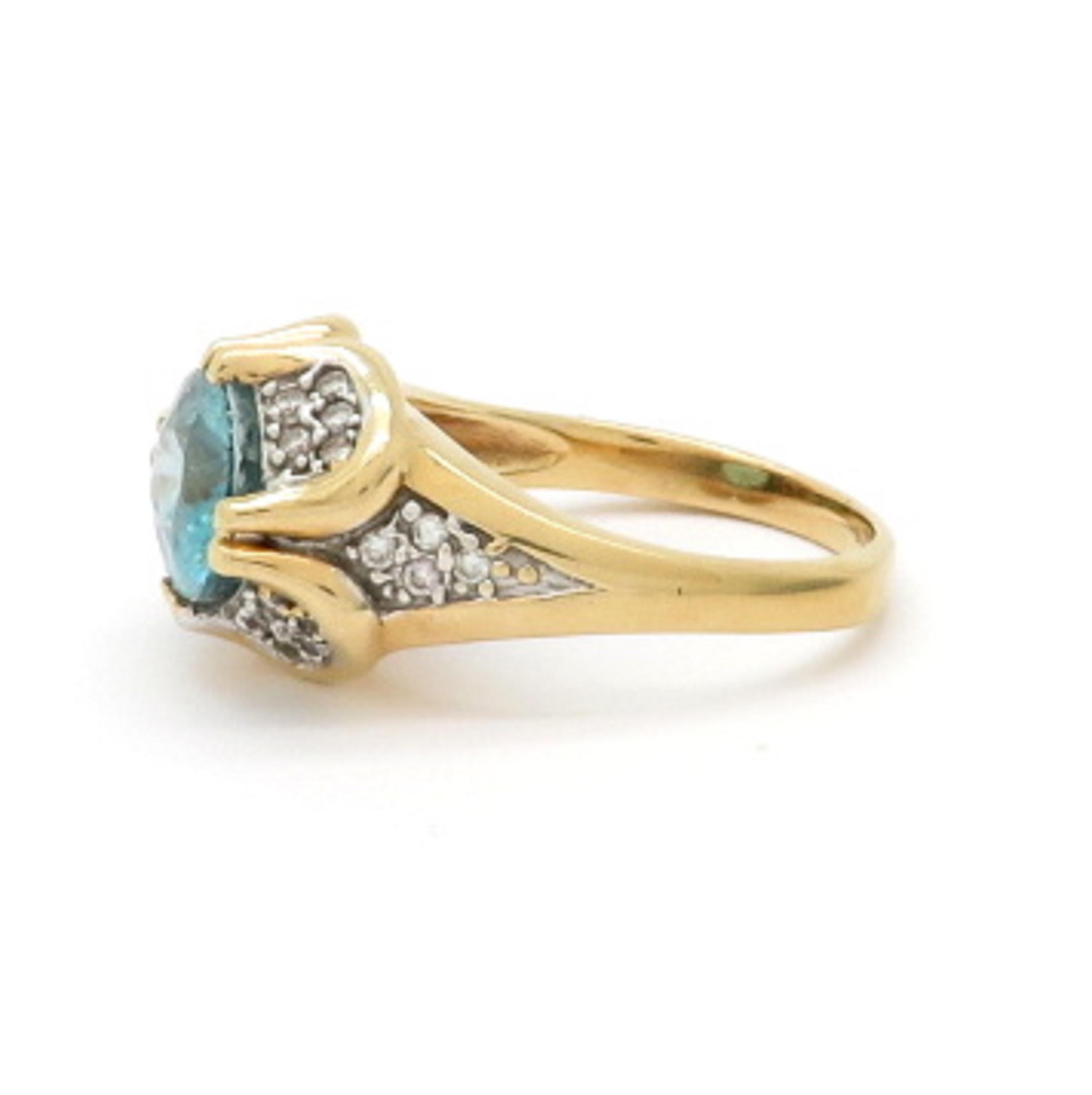 Estate 14K yellow gold 5.00 carat blue zircon and diamond ring. Showcasing one oval blue zircon fine quality gemstone weighing approximately 5.00 carats. Accented with 28 pave set round brilliant cut diamonds weighing a combined total of 0.30