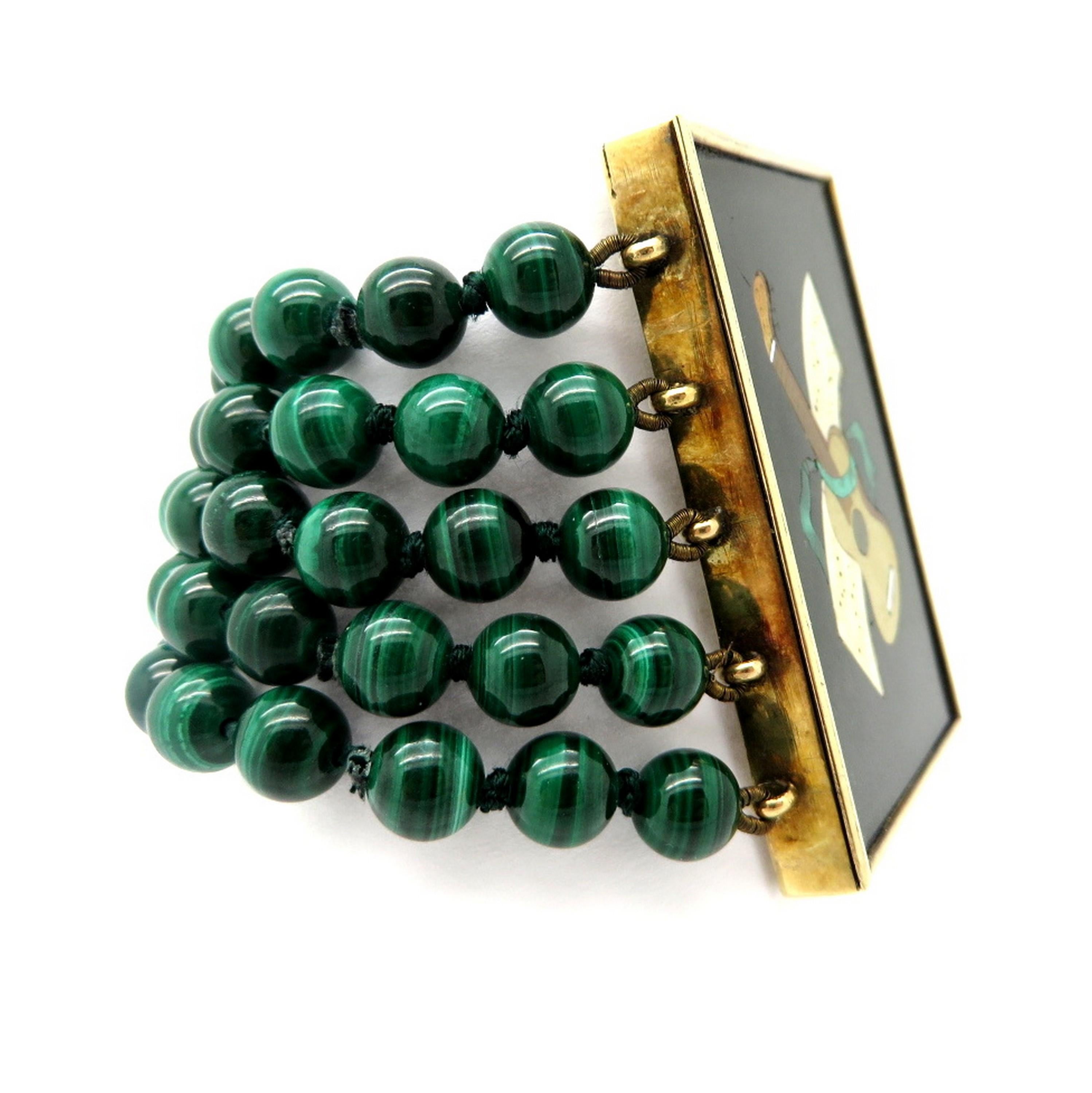 Estate 14K yellow gold one-of-a-kind malachite guitar fashion bracelet. Featuring five rows of American cut round beaded malachite gemstones, each measuring 6.5 to 6.7 mm. The bracelet features an artistic mosaic inlay link featuring a guitar with a