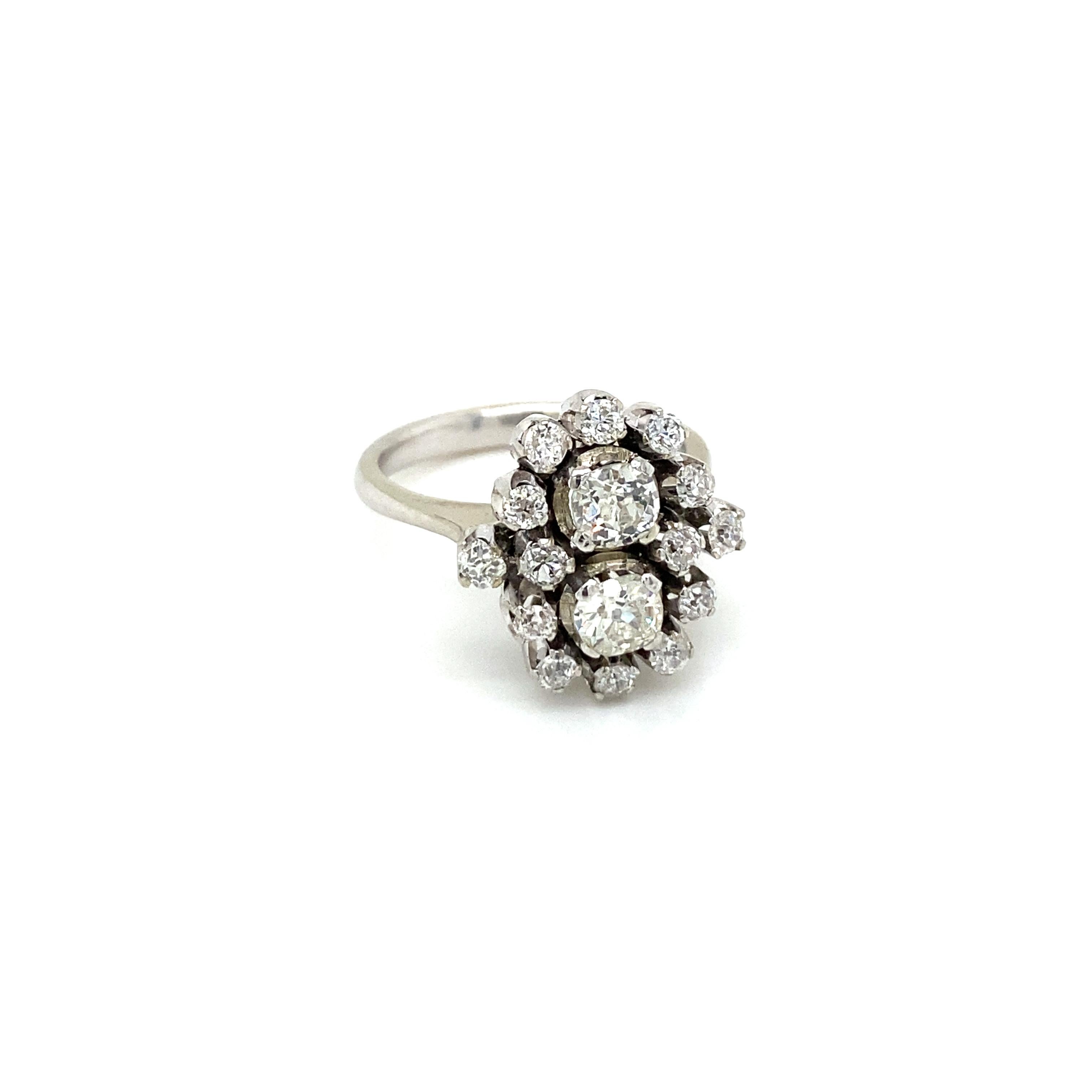 An exquisite example of Retro jewel. This ring is hand-crafted in 18k white gold, authentic from 1950', featuring in the center two large and sparkling Old mine-cut Diamonds weighing 1 carat together, graded I color Vs2 clarity, and framed in a