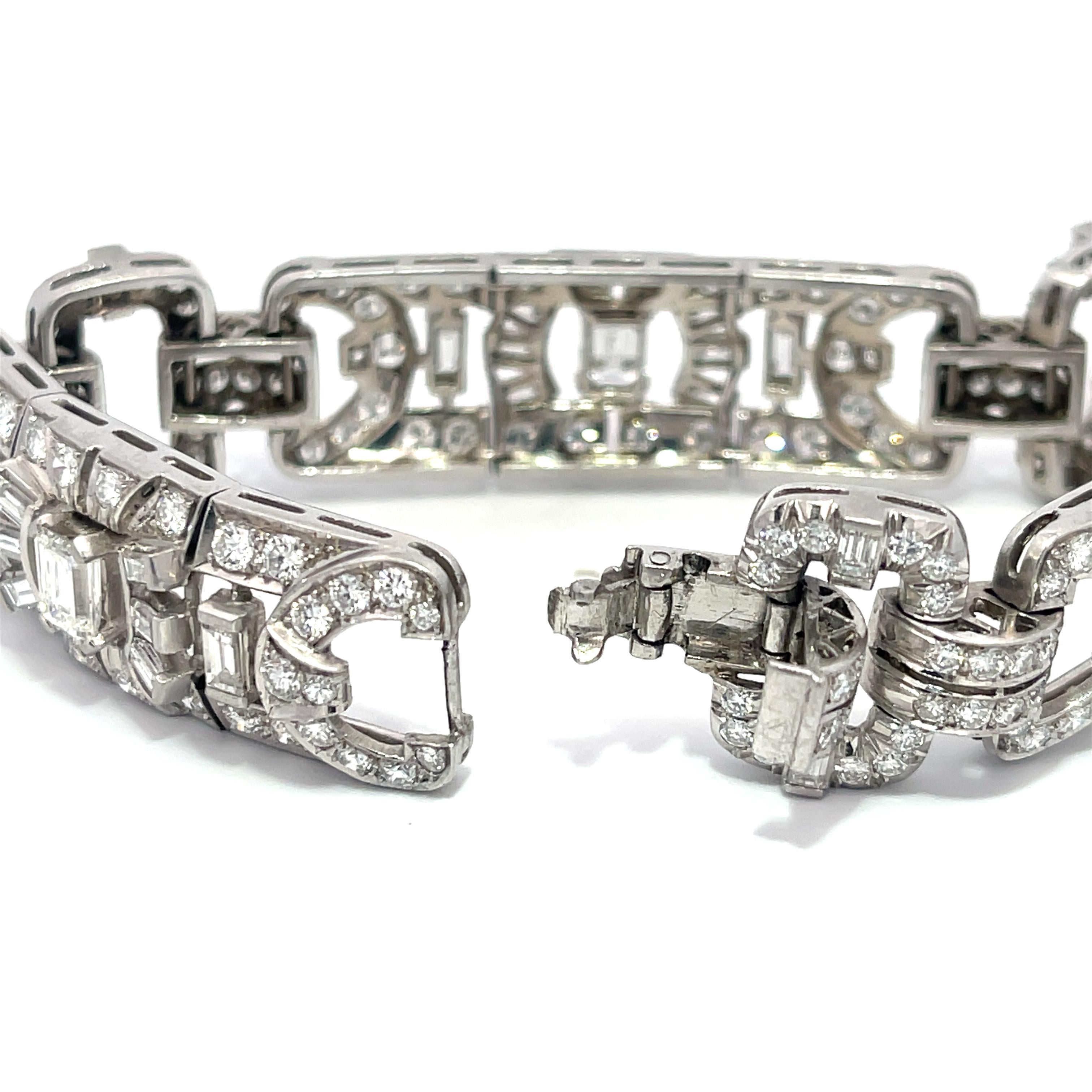 Estate Diamond Bracelet in Platinum. The bracelet features 17.50ctw of emerald, baguette, and round cut diamonds. The bracelet is 7 inches long, weighs 51.4 grams, and is 0.75 inches wide.
