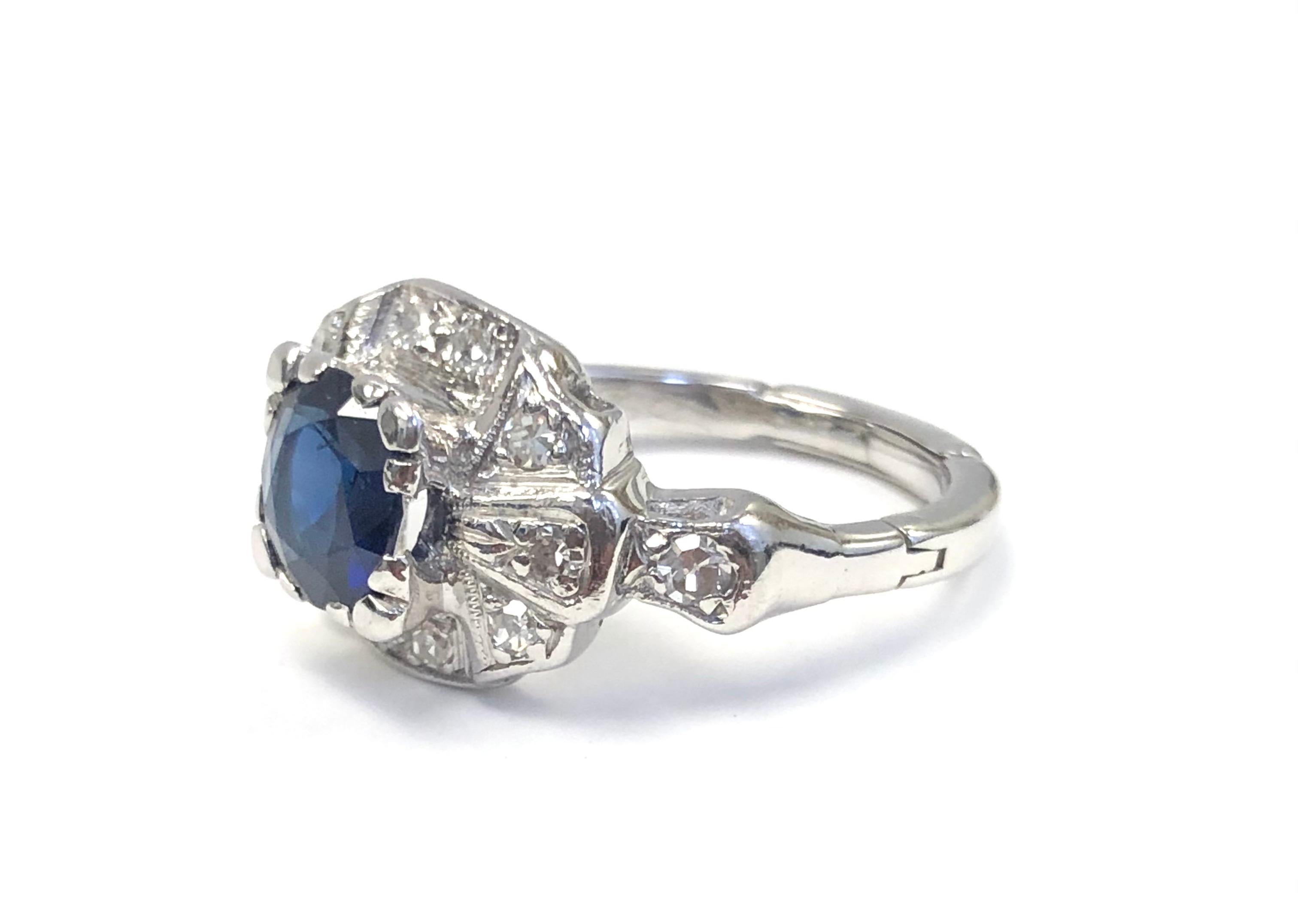 This Deco style Estate ring, is made in 18K White Gold, set with 12 diamonds 0.48 carats and an Oval Burma Sapphire 1.30 carats.
This Ring is fitted with a mechanism that when it is closed it's size 6-3/4 but it opens at the bottom to allow tge ring