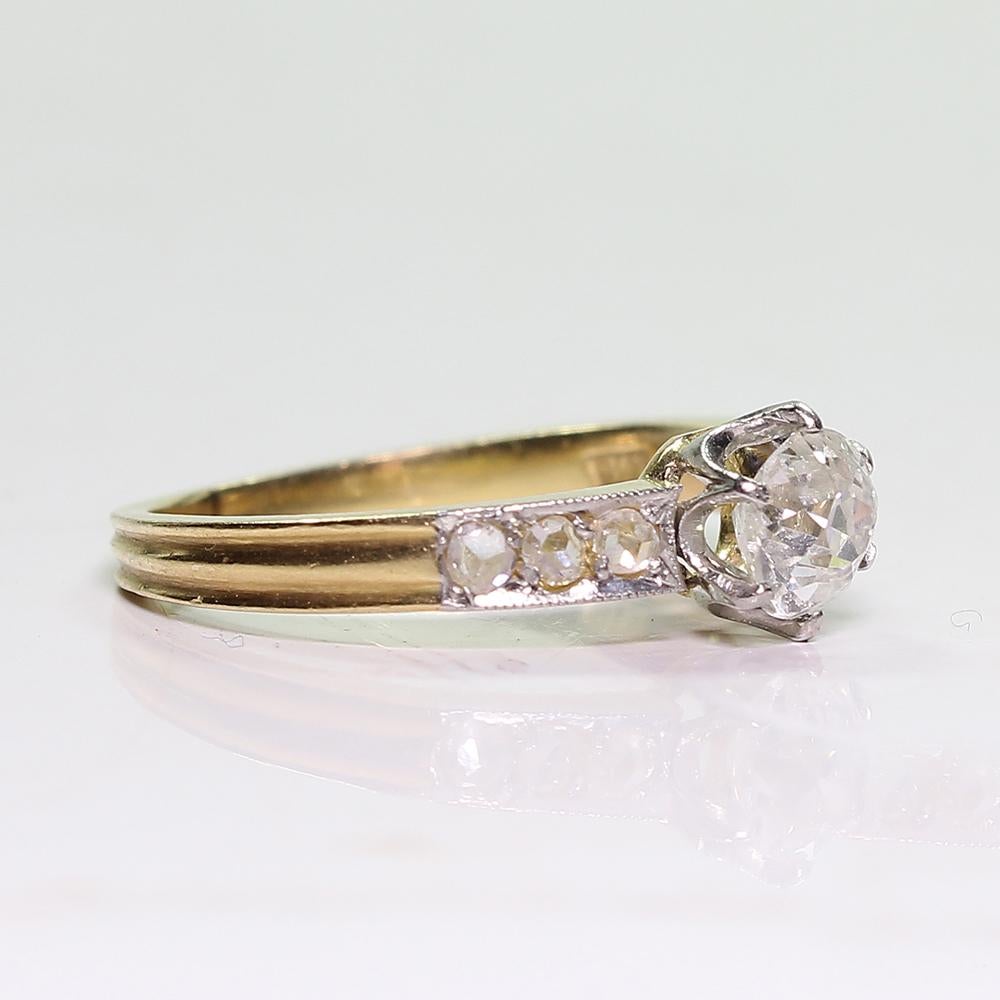 Period: Art Deco (1920-1935)
Composition: 18K gold and platinum

Stones:
•	1 Old mine cut diamond of H-VS2 quality that weighs 0.70ctw. 
•	6 Rose cut diamonds of J-SI1 quality that weigh 0.30ctw.

Ring size: 6  (Resizing available)
Ring face:  19mm