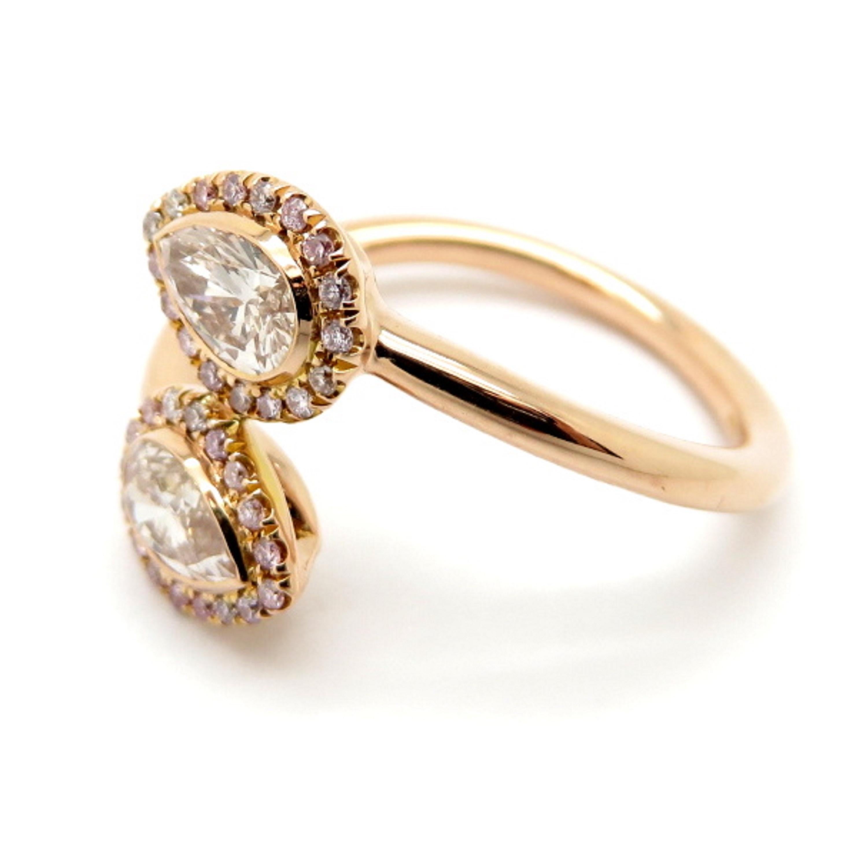 For sale is a beautiful diamond halo ring featuring pink diamonds! It is crafted out of solid 18K rose gold. Showcasing two (2) bezel set pink pear brilliant cut diamonds weighing approximately 0.67 carats total. Accenting the diamonds in a halo