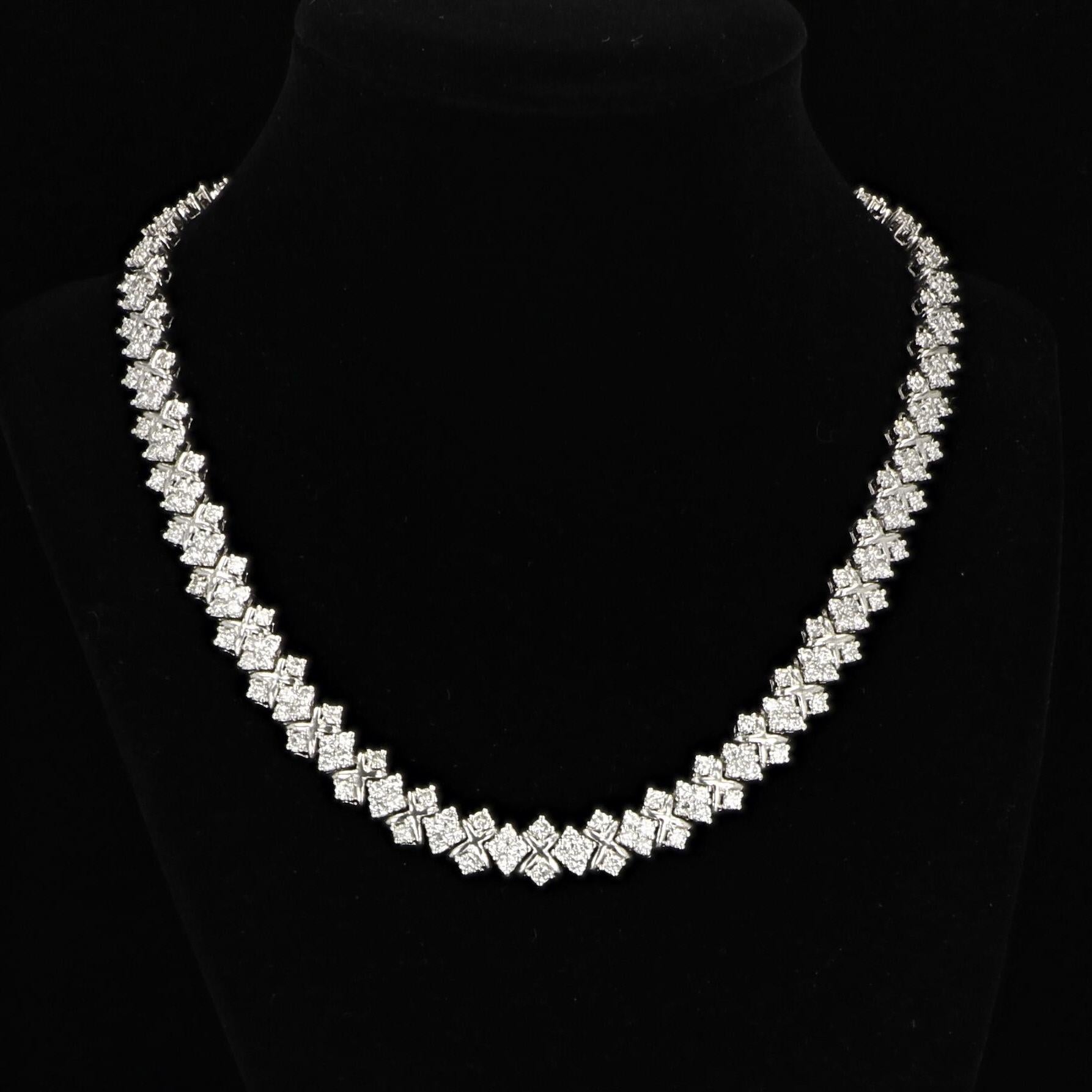 This 18k white gold diamond link necklace is set with approximately 269 round brilliant diamonds together weighing approximately 18.00 carats. The diamonds have average color of G-H and average clarity of SI1. The necklace measures 10mm in width by