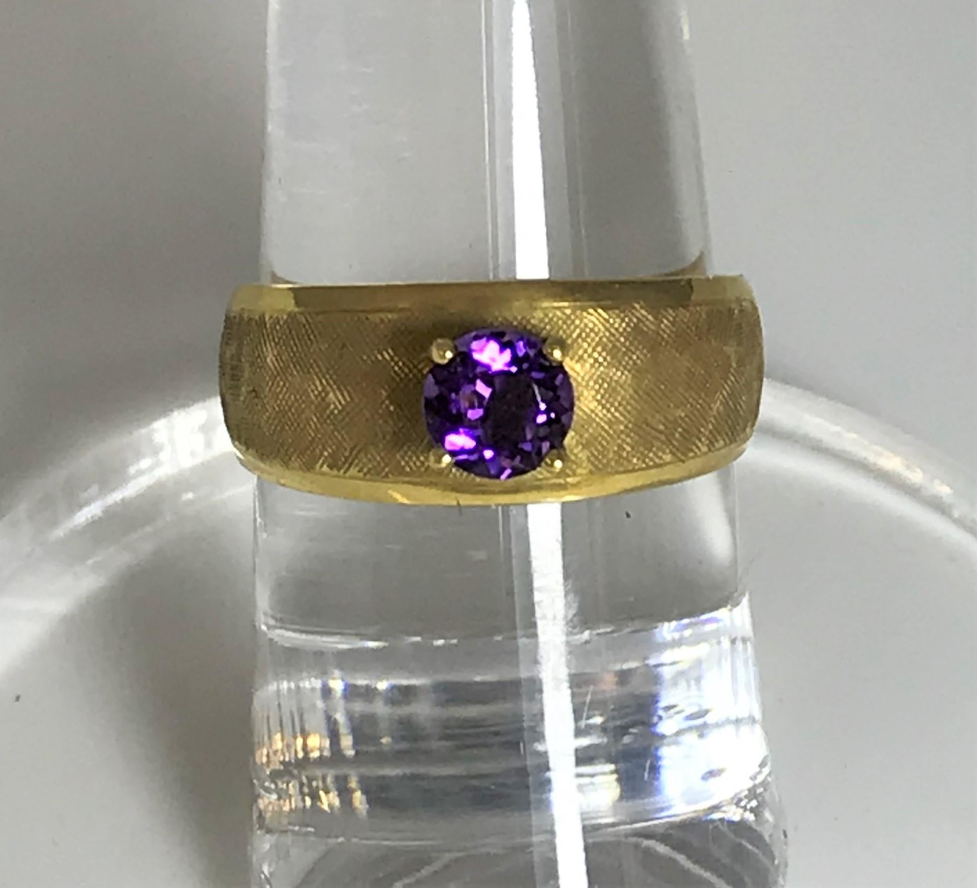 February birthday, engagement, everyday ring that will make anyone smile. 
5mm round amethyst 
4 prong setting
18K yellow gold band measuring approximately 8mm at top, narrowing to 4mm at the bottom
Florentine finish
Size 6.5
