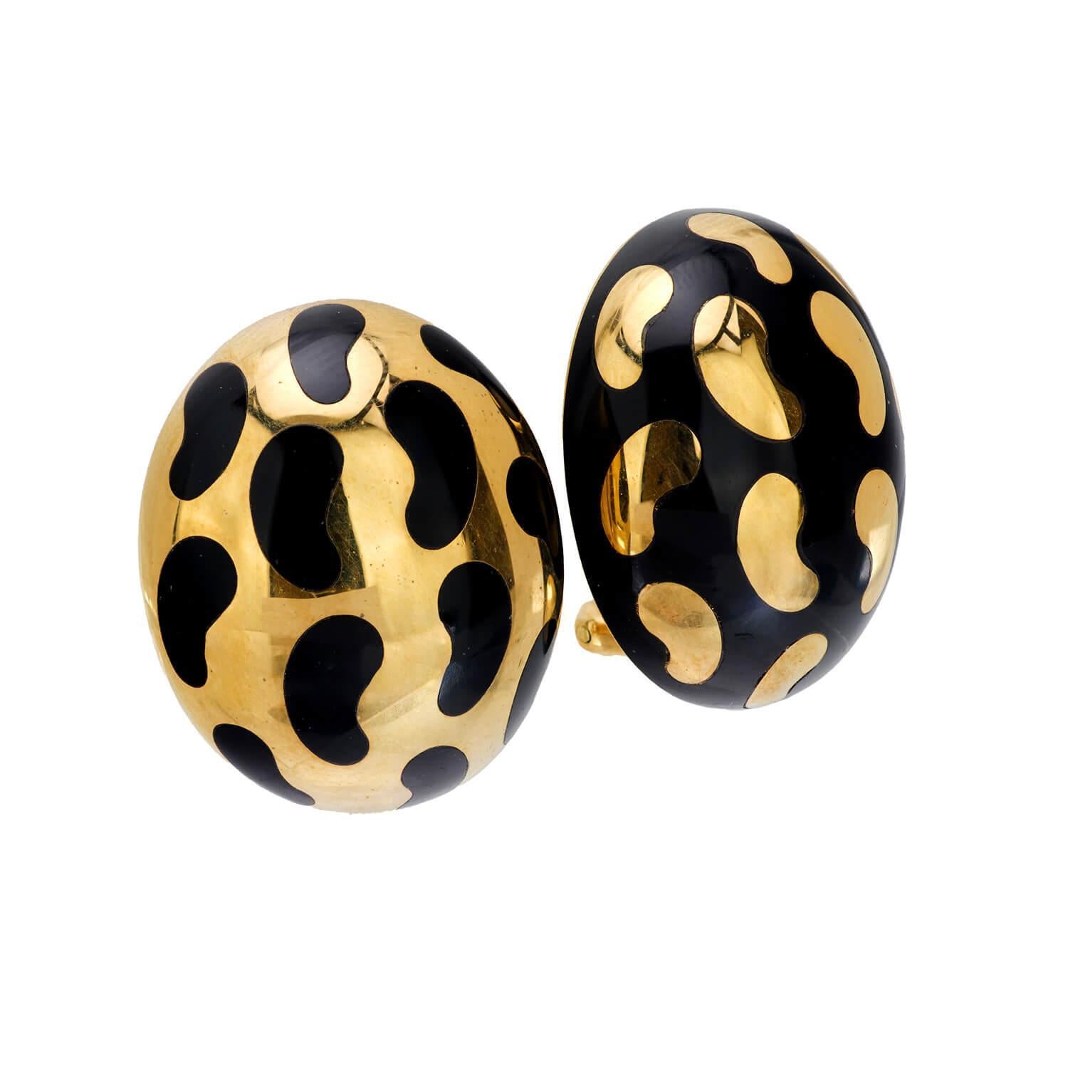 A bold pair of leopard print earrings! Crafted in 18k, the surface of each oval-shaped earring features a leopard print motif. The earrings feature an inverted design, with one featuring a black surface with gold spots, and the other featuring a