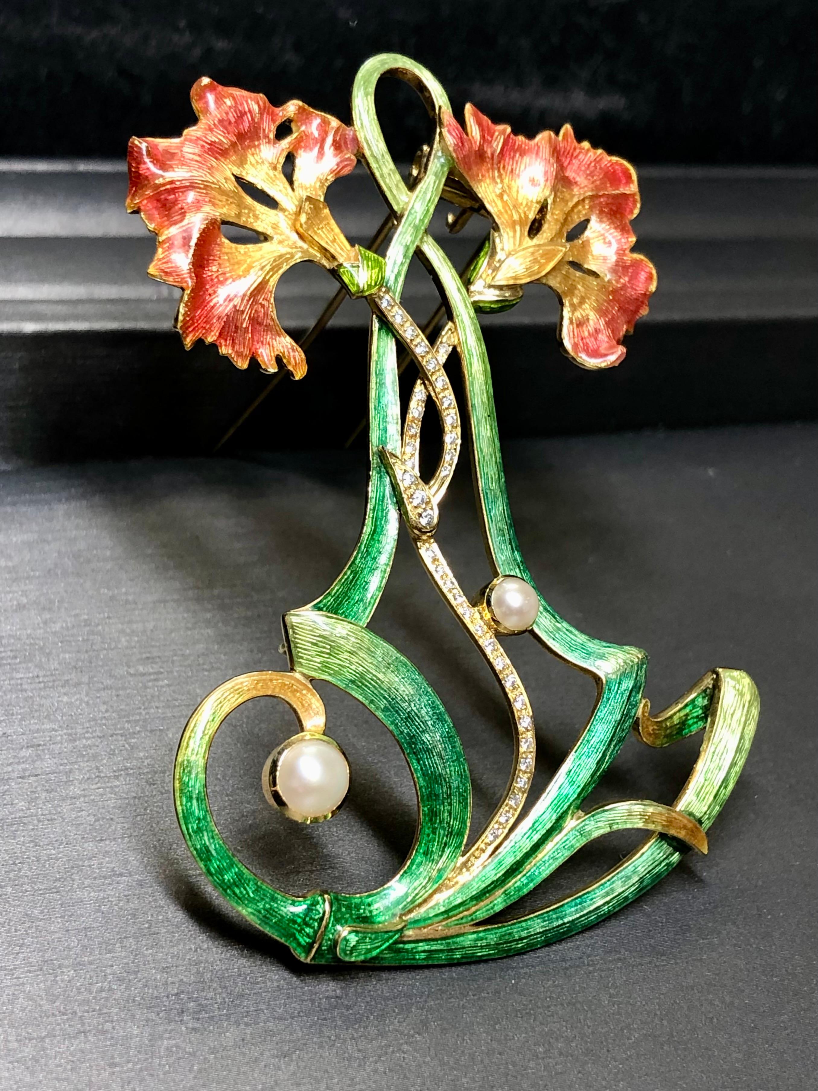 A fabulous piece done in the style of the Art Nouveau period. It is hand crafted in 18K yellow gold and gorgeously enameled throughout in vibrant greens, yellows and reds. The central portion stems are bead set with approximately .38cttw in H-I