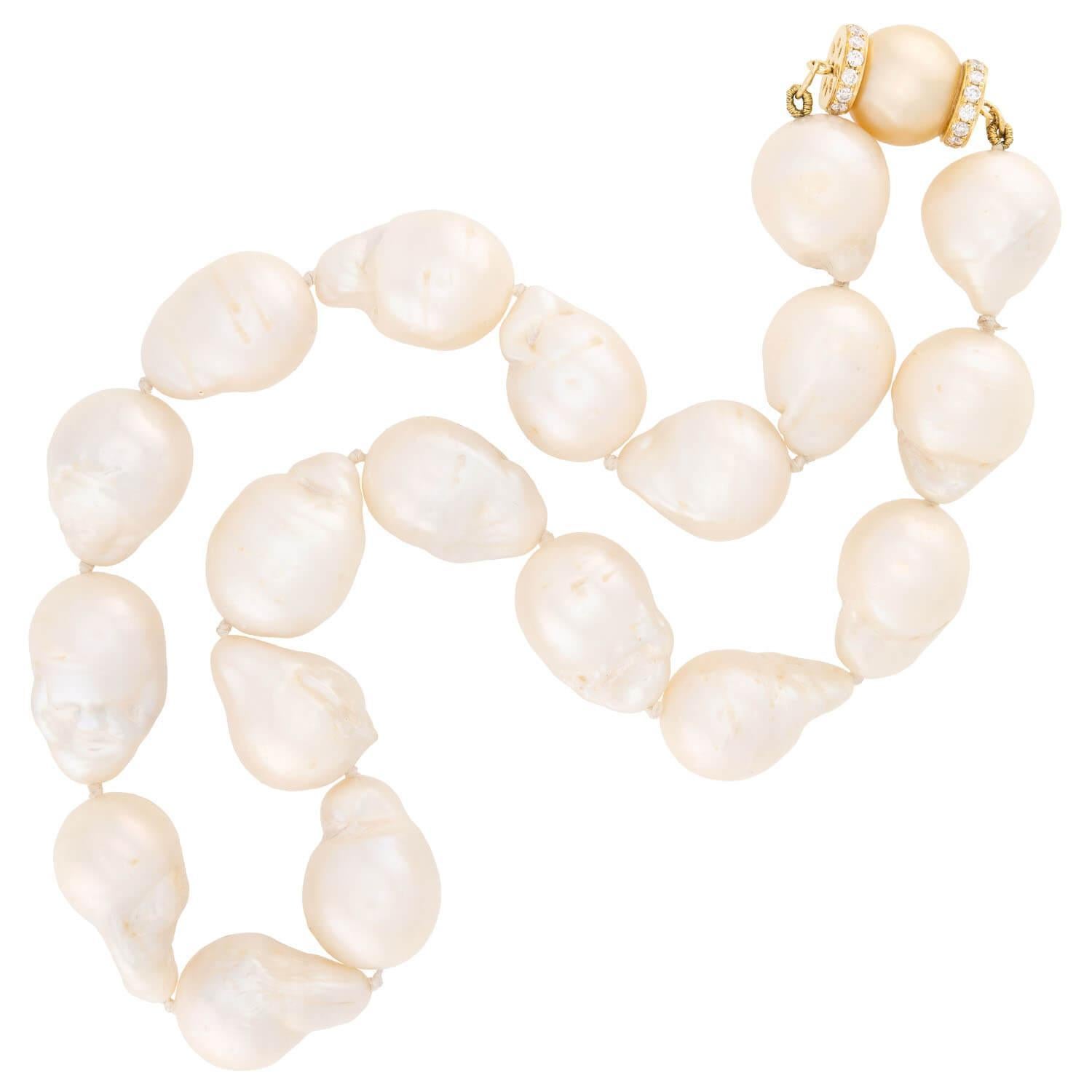 A classically beautiful pearl necklace!This delicate and feminine piece features a single strand of baroque pearls, which have a soft creamy white color and wonderful luster. The pearls vary slightly in size and shape. Each pearl is hand strung on