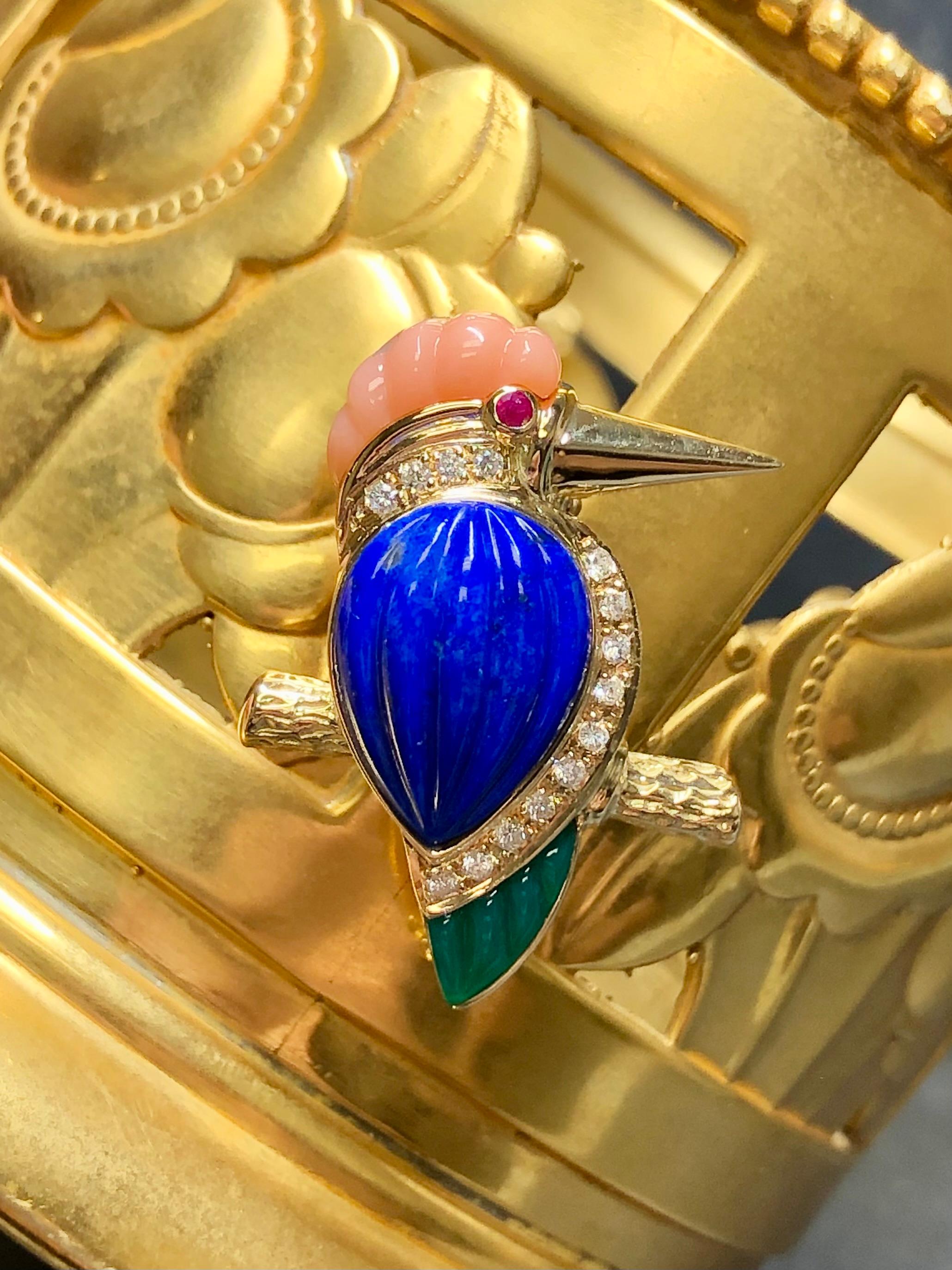 An exquisite little kingfisher pin done in 18K yellow gold set with carved lapis, coral and green chalcedony as well as .10cttw in G color and Vs1-2 clarity round diamonds. This pin also has a bale so that it may be worn on a small