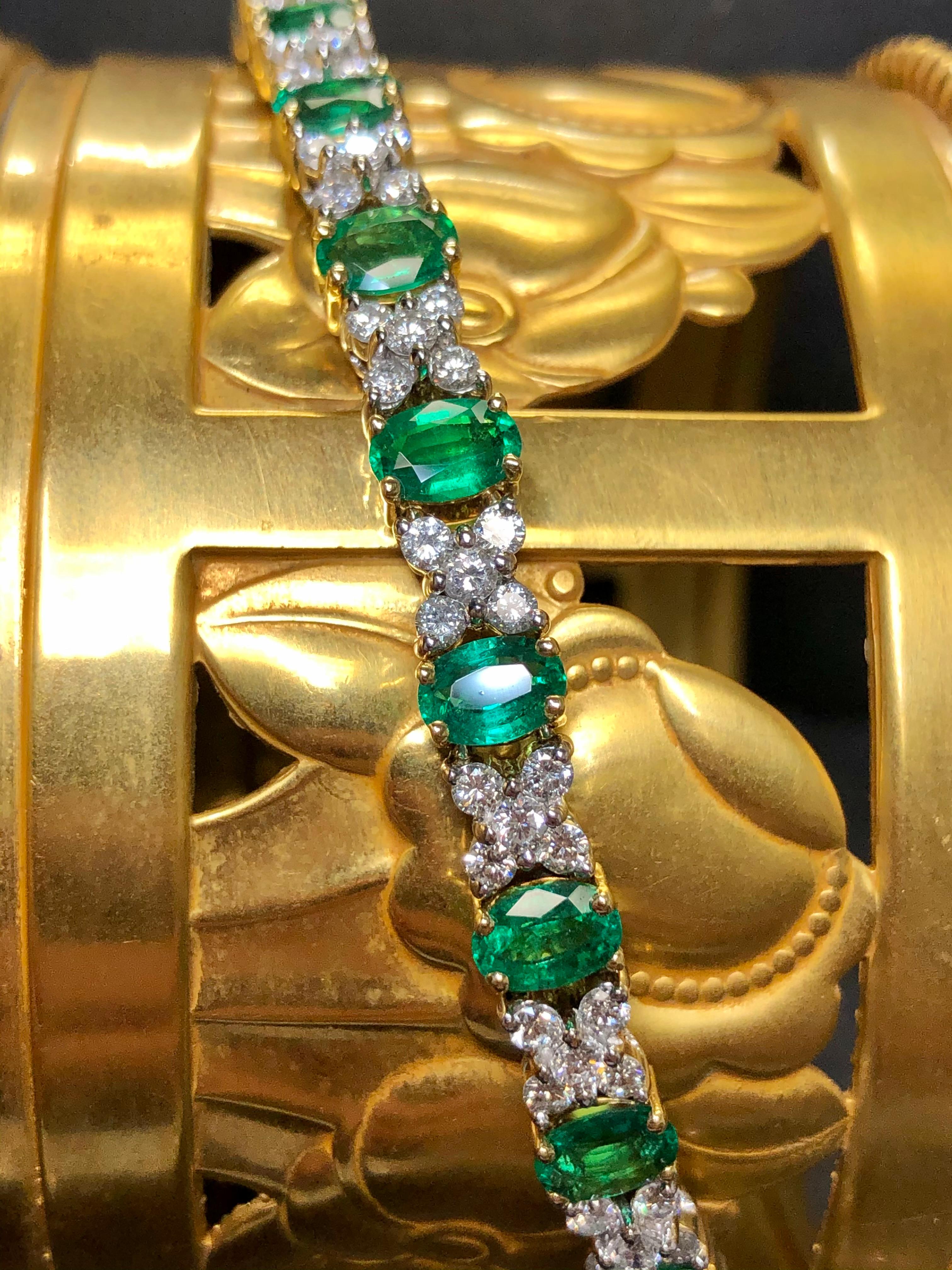 A spectacular bracelet hand crafted in 18K yellow and white gold set with the most incredible color natural oval cut emeralds with a total approximate weight of 8cttw. Separating each emerald are quad-set shared prong diamond sections containing