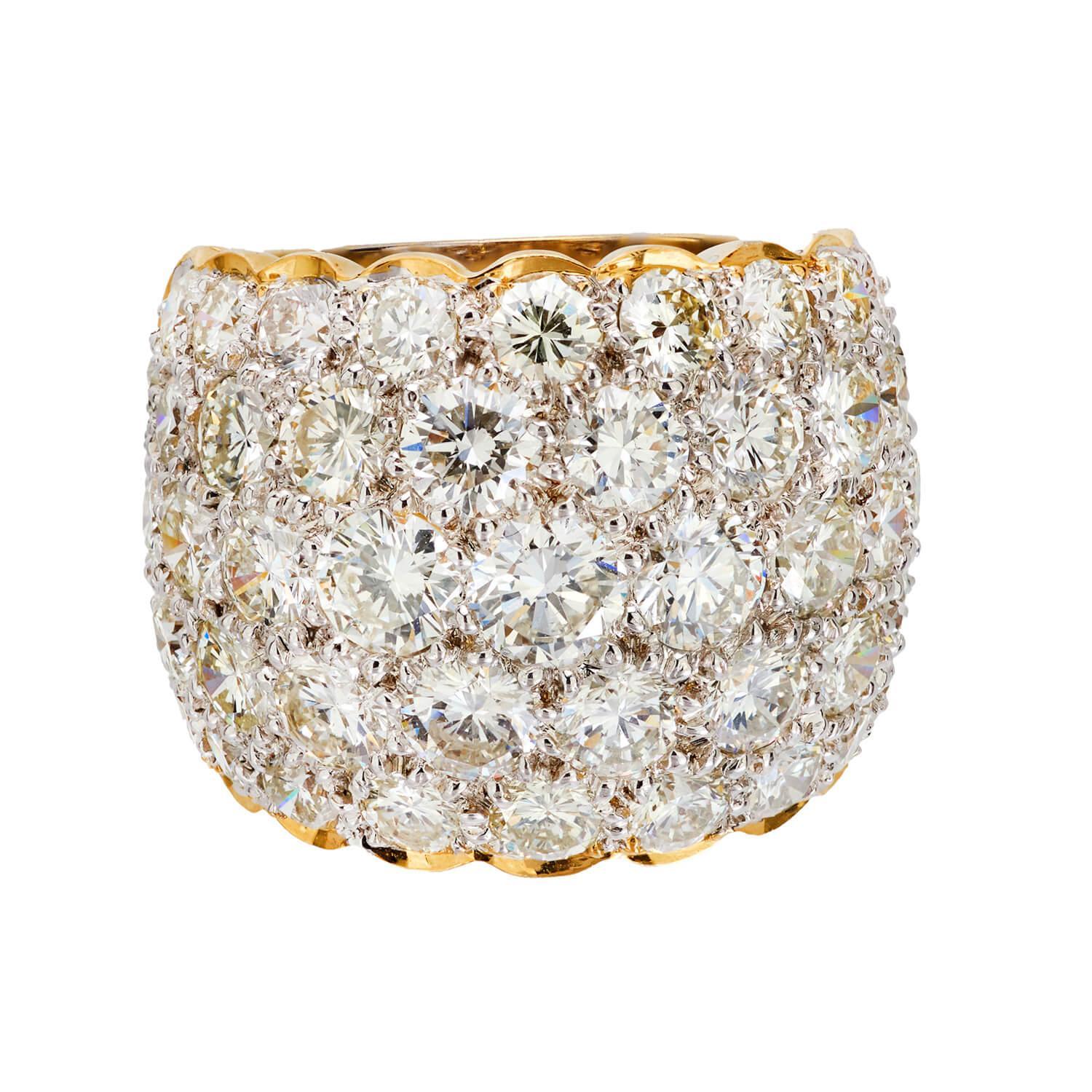 A fabulous diamond-encrusted cigar band! Crafted in vibrant 18k yellow gold, the front surface of the substantial ring is encrusted with modern round brilliant diamonds, which are all bead-set. The stones vary slightly in size, but overall have an