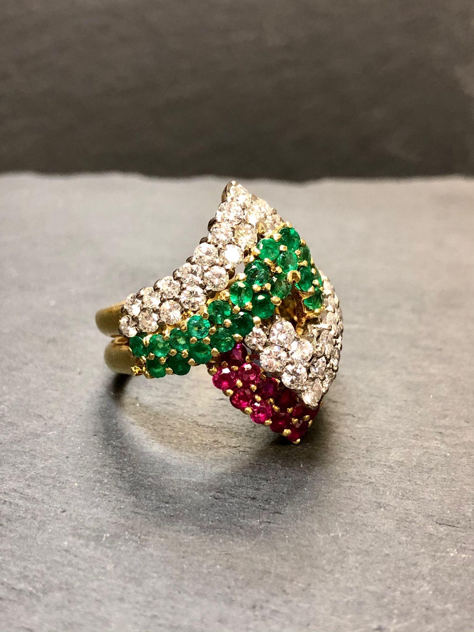 
Italian made 18K chevron ring set with approximately 2.10cttw in G-H color Vs clarity rounds diamonds, 1.68cttw in natural rubies and 1.10cttw in natural emeralds.

Condition
All stones are secure. In very wearable