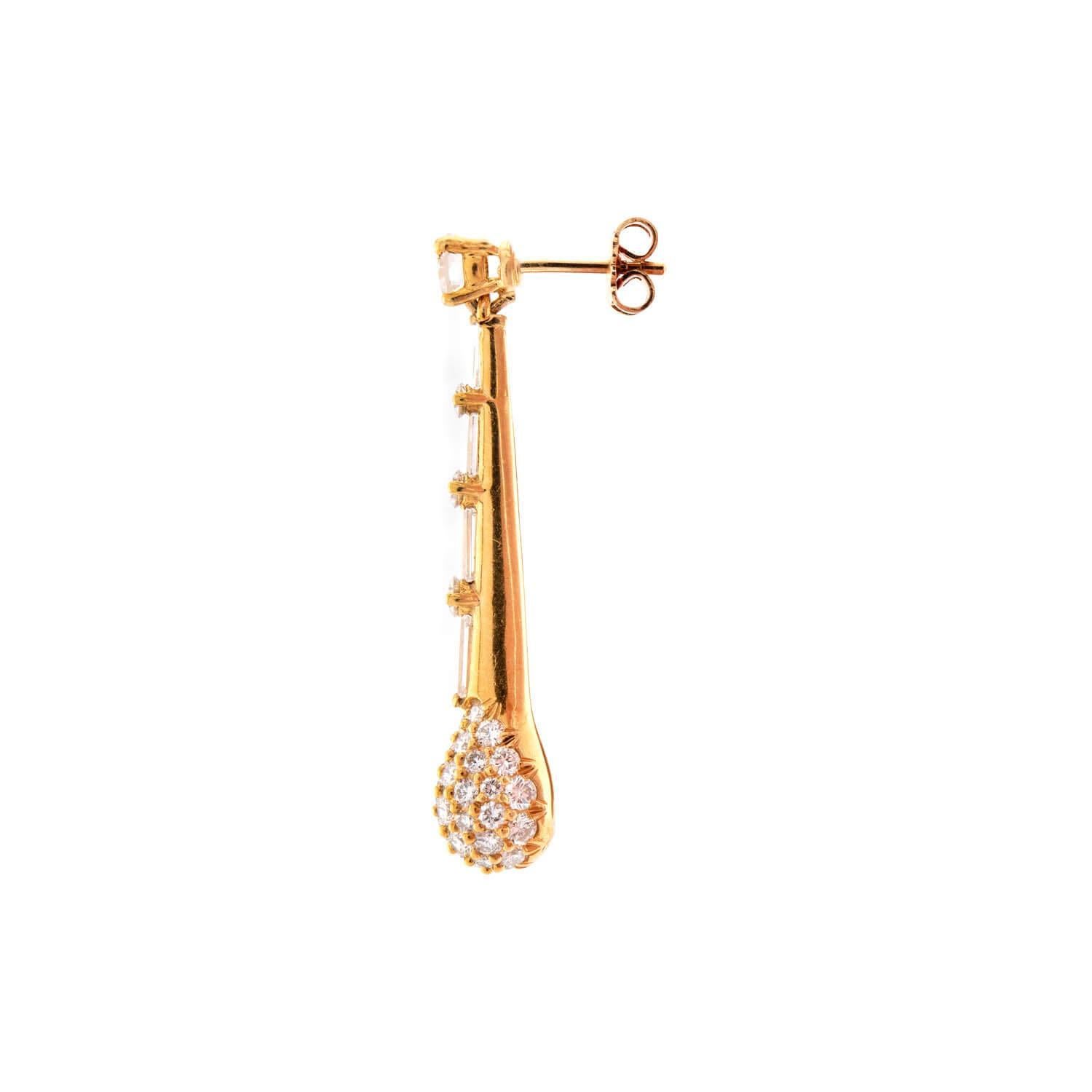 A unique and eye-catching pair of earrings! Crafted in 19k vibrant yellow gold, each earring begins with a modern round brilliant-cut diamond surmount. The diamond is held within a four-prong setting. The earrings then feature a matchstick-motif