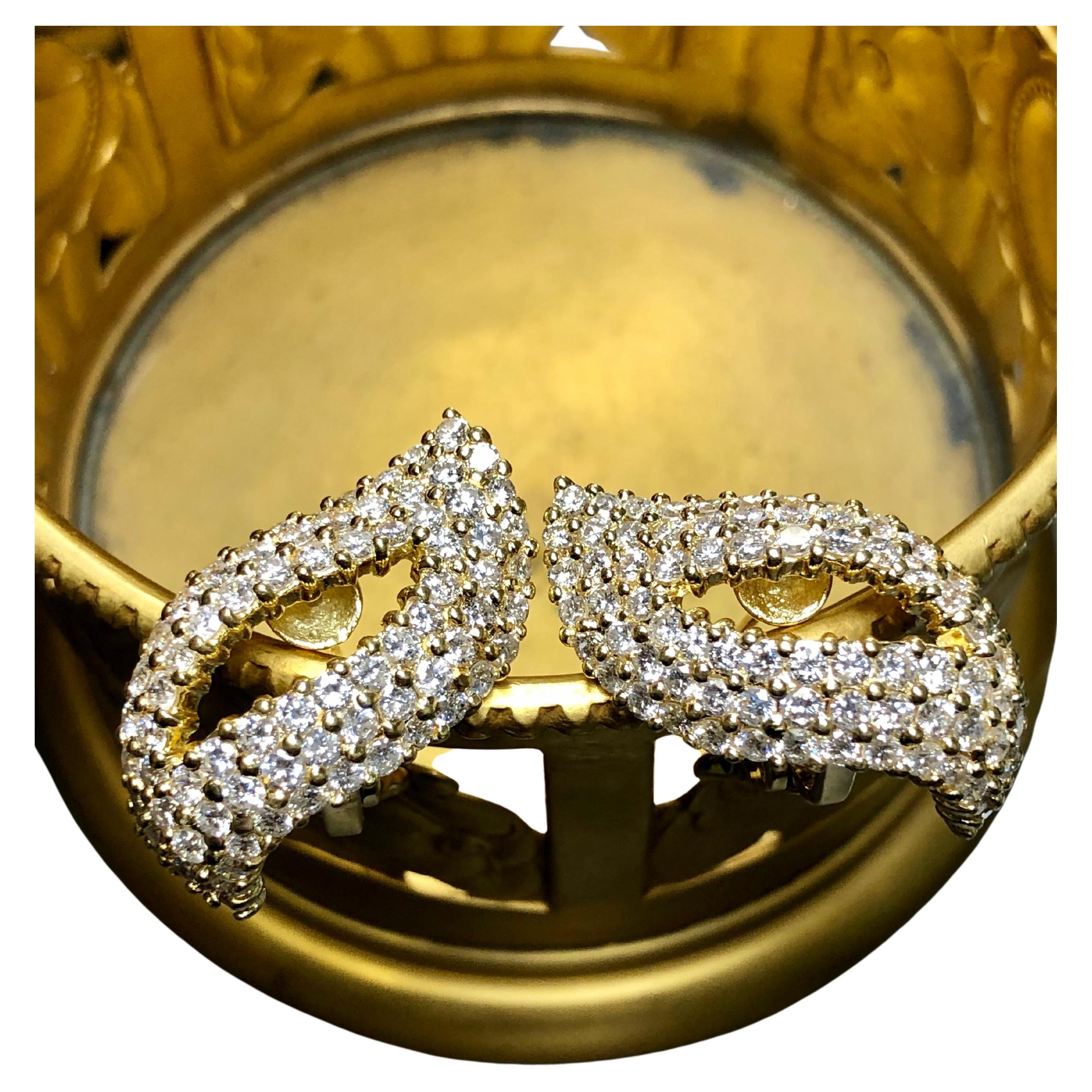 An elegant pair of huggie earrings crafted in 18K yellow gold and prong set with approximately 6.50cttw in G-H color Si1-2 clarity round diamonds. They are pierced with omega backs.


Dimensions/Weight:

Earrings measure 1.1” long by .60” wide and