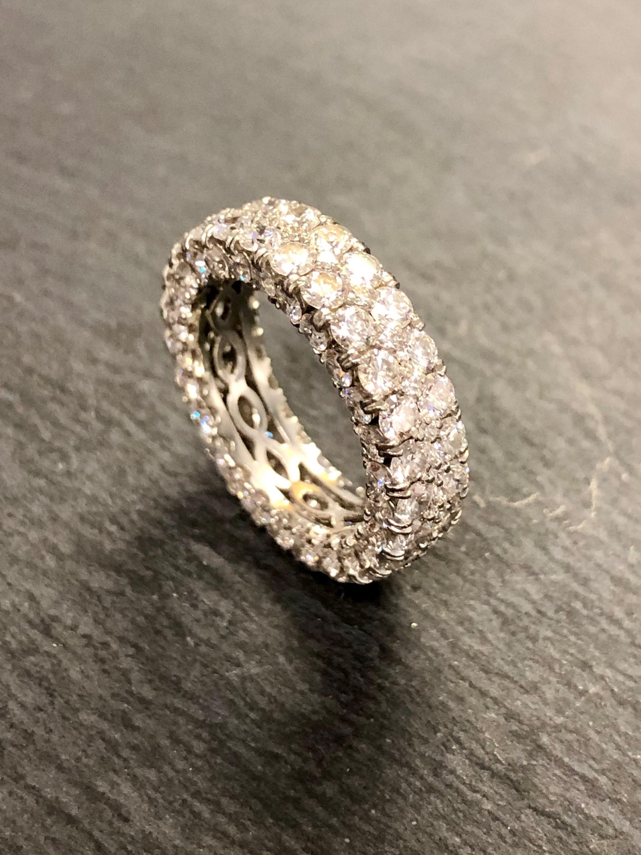 A beautifully done band done in 18K white gold set on the top and sides with 5 rows of G-H color Vs1-2 clarity diamonds with a total approximate weight of 5.50cttw.

Dimensions/Weight
5.75mm wide and it is a size 6. Weighs 3.6dwt.

Condition
All