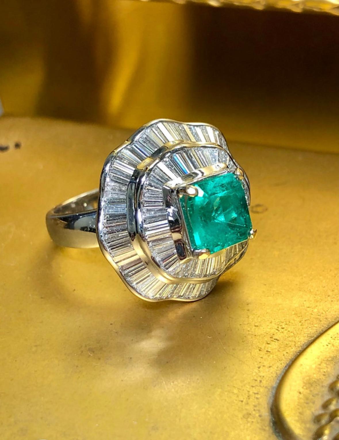 This ring is fabulous! The diamonds flow like water and the Emerald is so green and bright that it looks electric! It has been crafted in 18K white gold and set with approximately 5cttw in F-G Vs1 clarity baguette diamonds and centered by an
