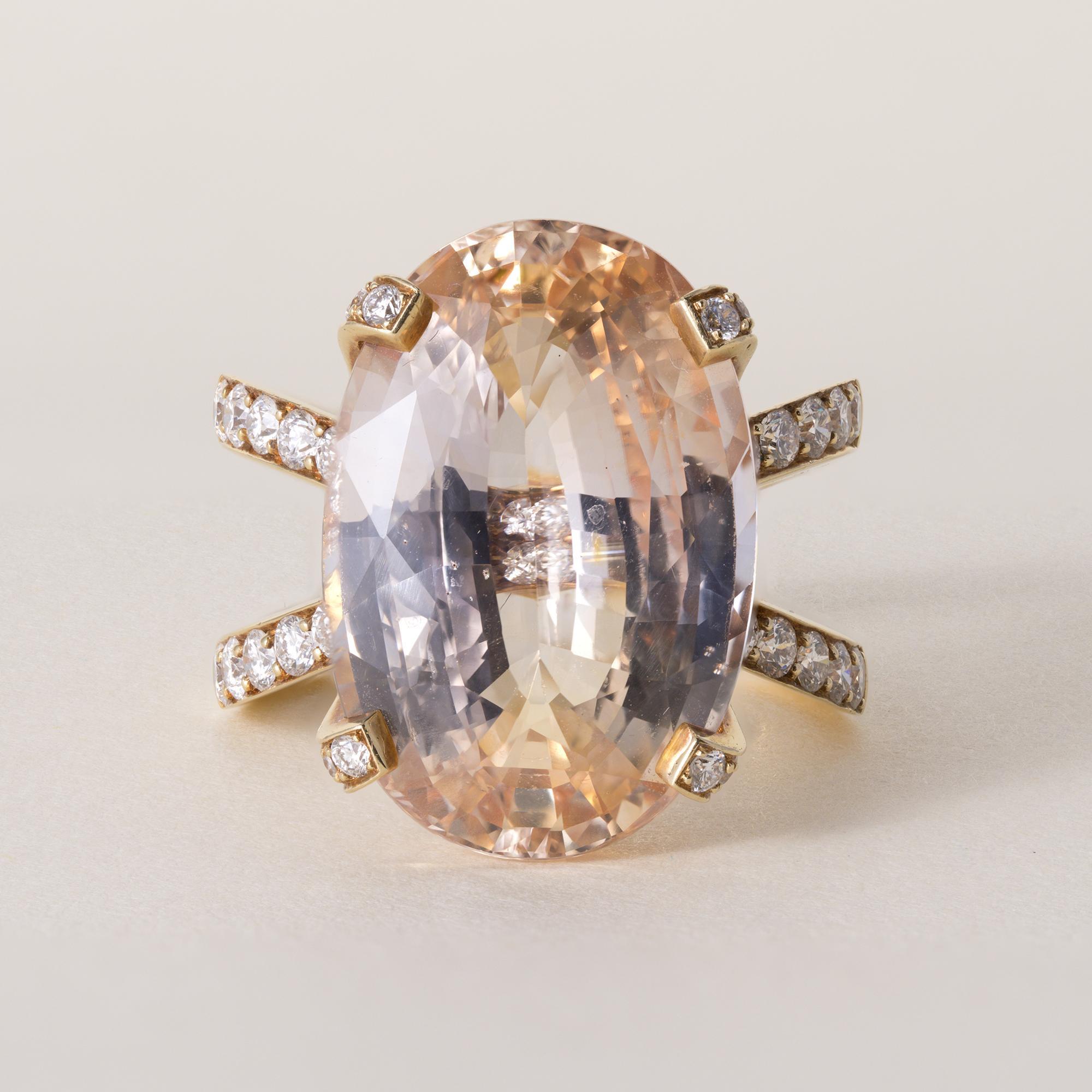 Estate 18K Gold 16.46 Carat No-Heat Orange Sapphire & Diamond Ring

A remarkable estate statement ring showcasing an impressive unheated 16.46 carat sapphire, soft light peach-orange hue glowing with rare natural beauty. Surrounding the sapphire,